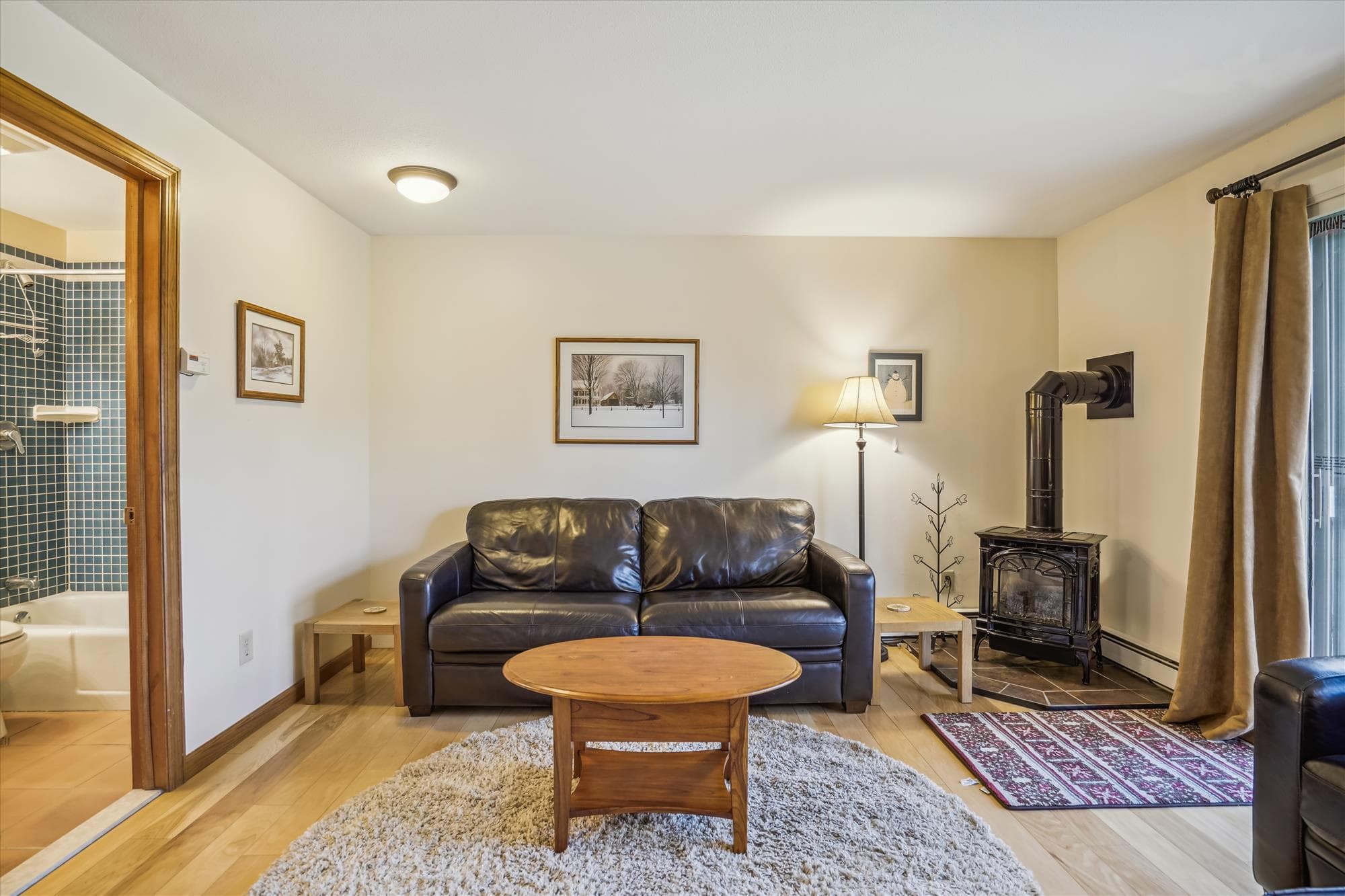Living room with plenty of seating for your small group. Propane stove to enjoy and warm up after those cold days or just to add some ambiance to your evening. Sleeper sofa access