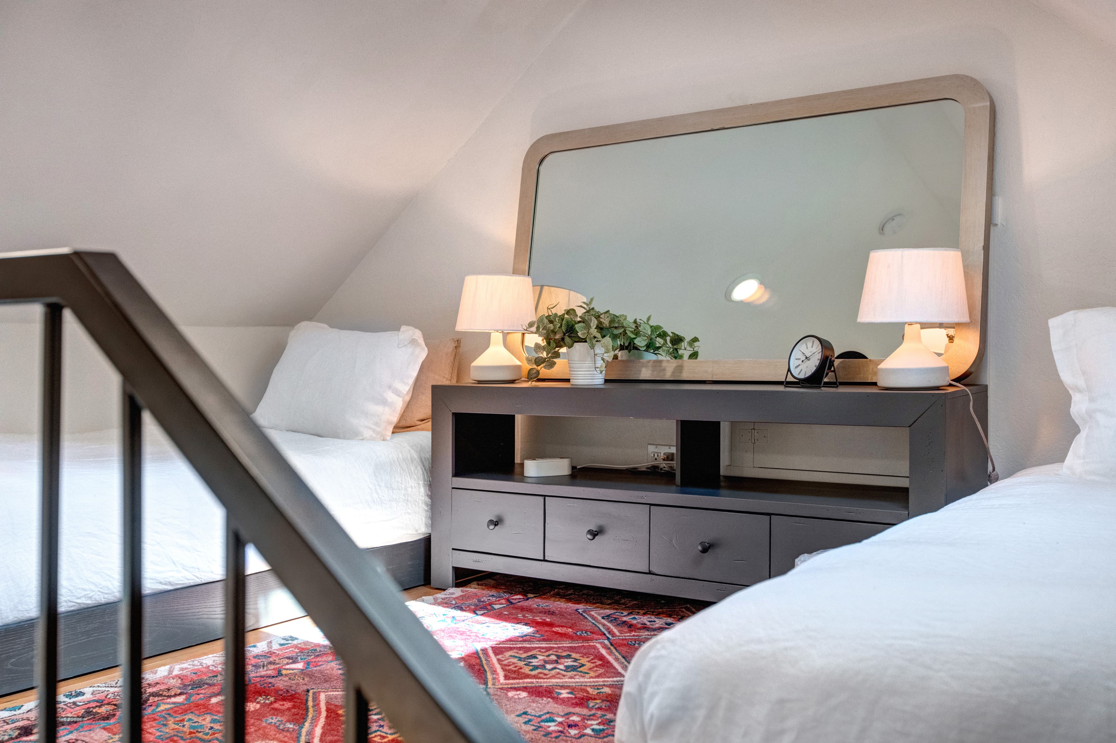 Master king bedroom, with ensuite bathroom and vaulted ceilings with a ladder up to an open loft with two additional twin beds.