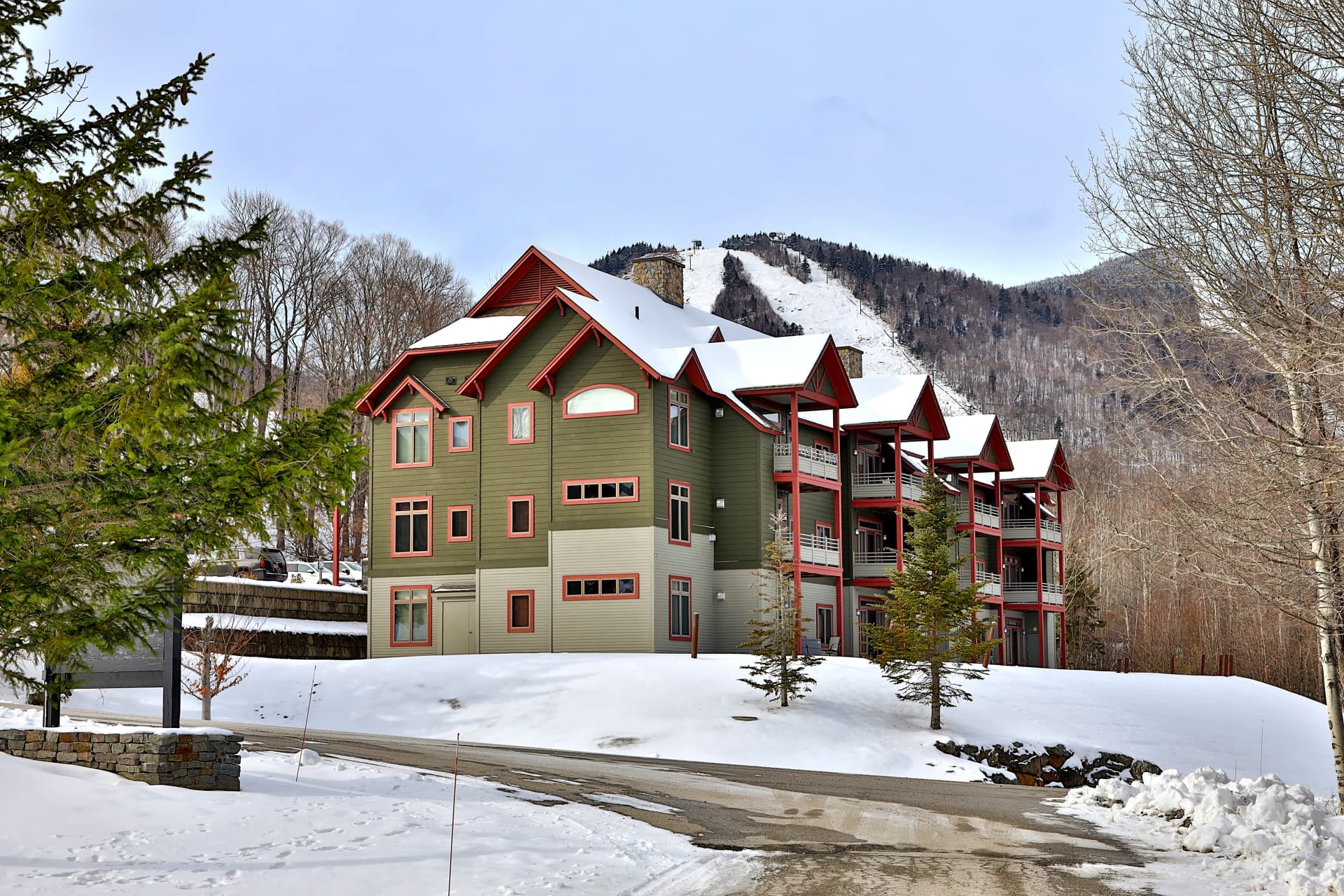 Winter view of The Lodges complex surrounded by mountain scenery. Crisp architecture with easy parking and quick access to nearby trails and resort areas.