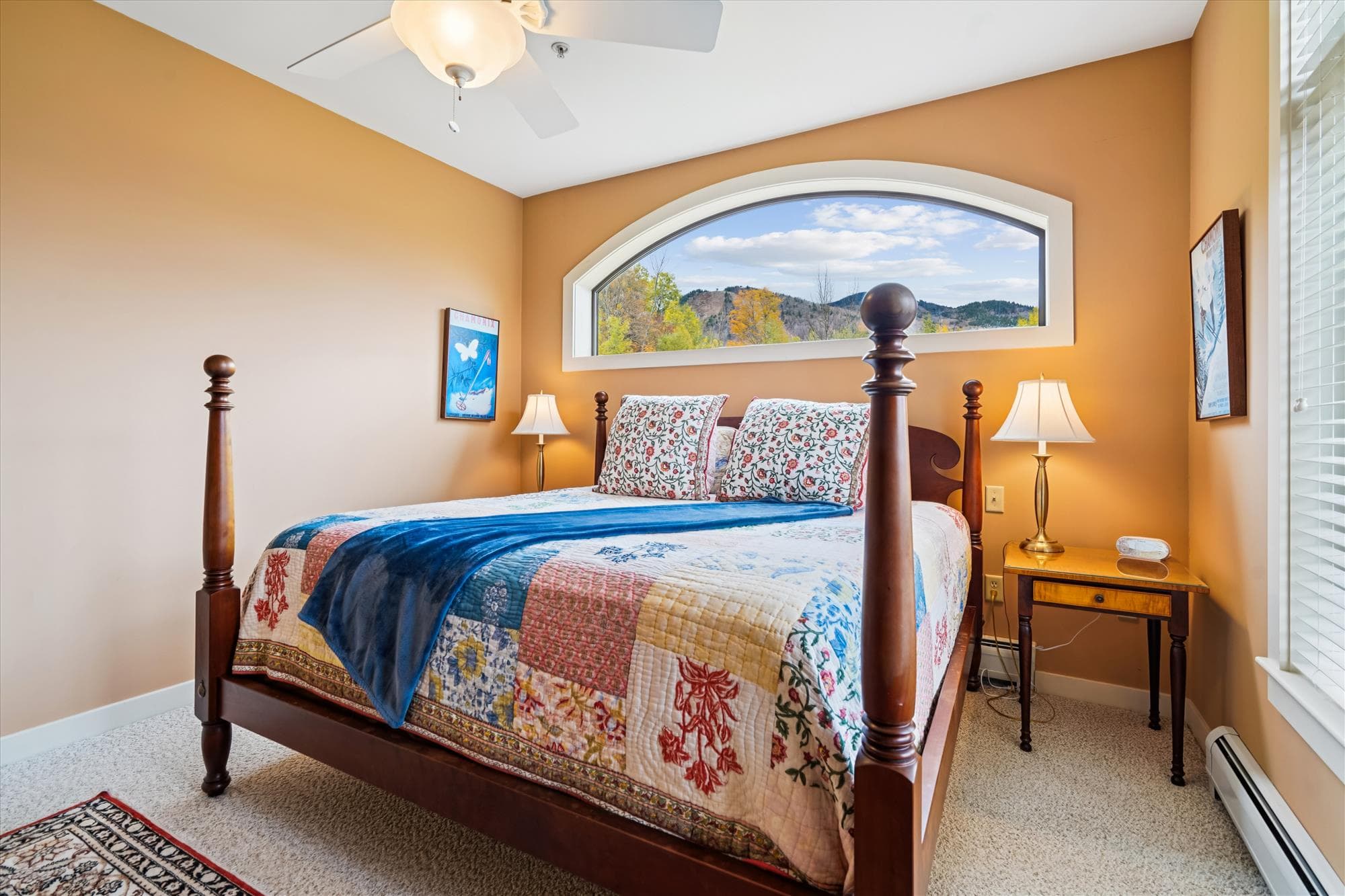 Relax in this king bedroom featuring mountain views, a classic four-poster bed, and natural light that fills the space. Perfect for unwinding after a day of skiing, hiking, or exploring Killington.