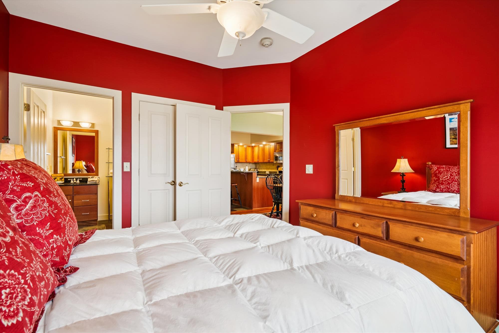Queen bedroom with rich color, mountain views, and a private bathroom—perfect for guests who appreciate both comfort and privacy.