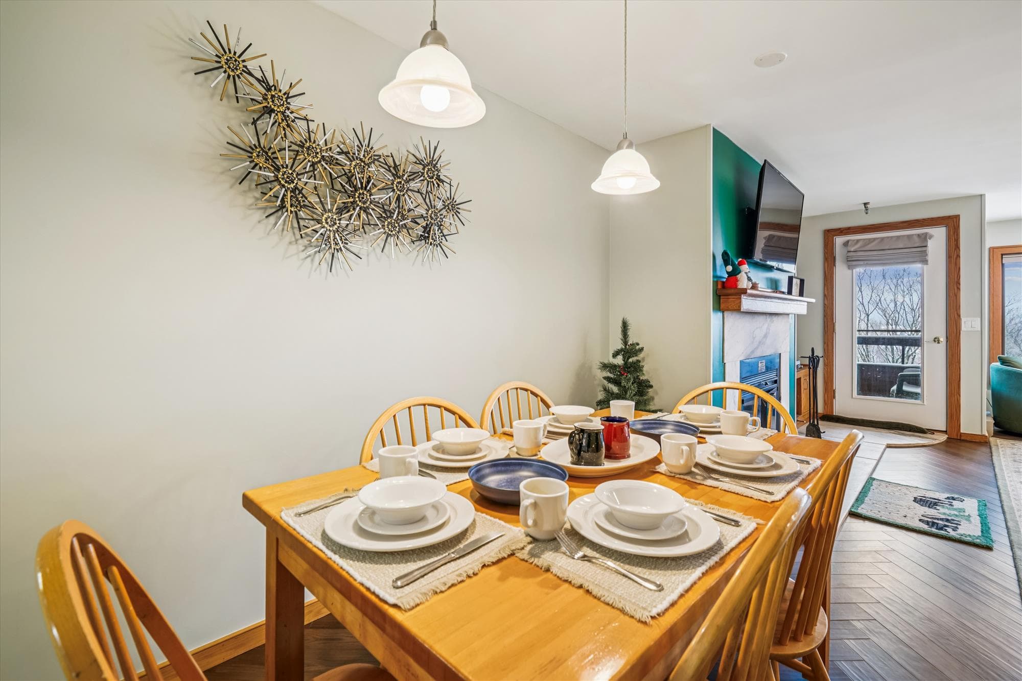 Enjoy meals together in the bright dining area, conveniently located beside the warm and inviting living room fireplace and balcony access.