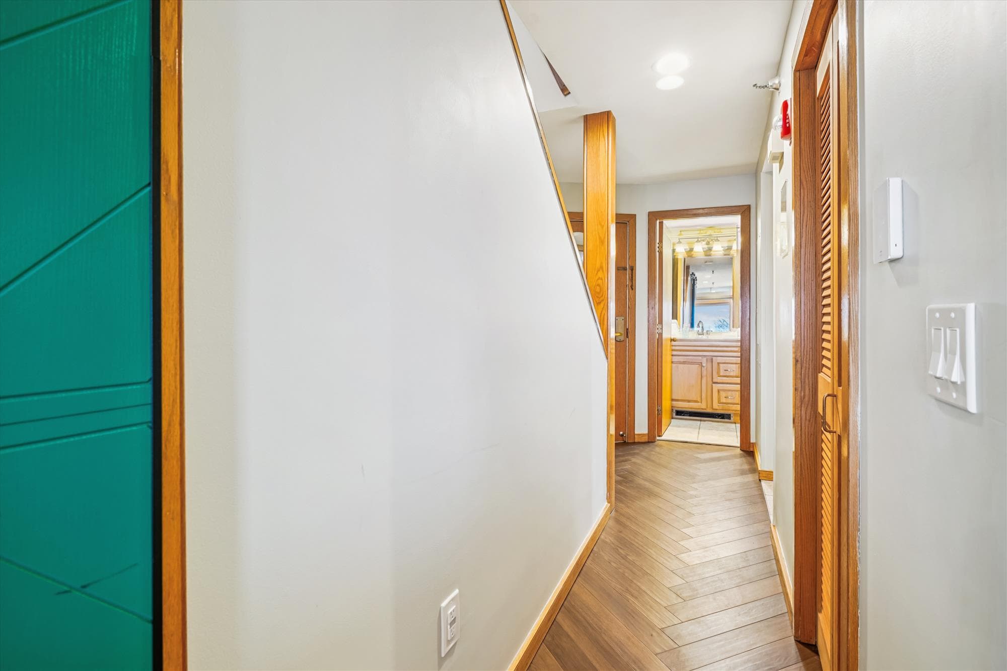 Hallway connecting the entry area, bathroom, and main living space.