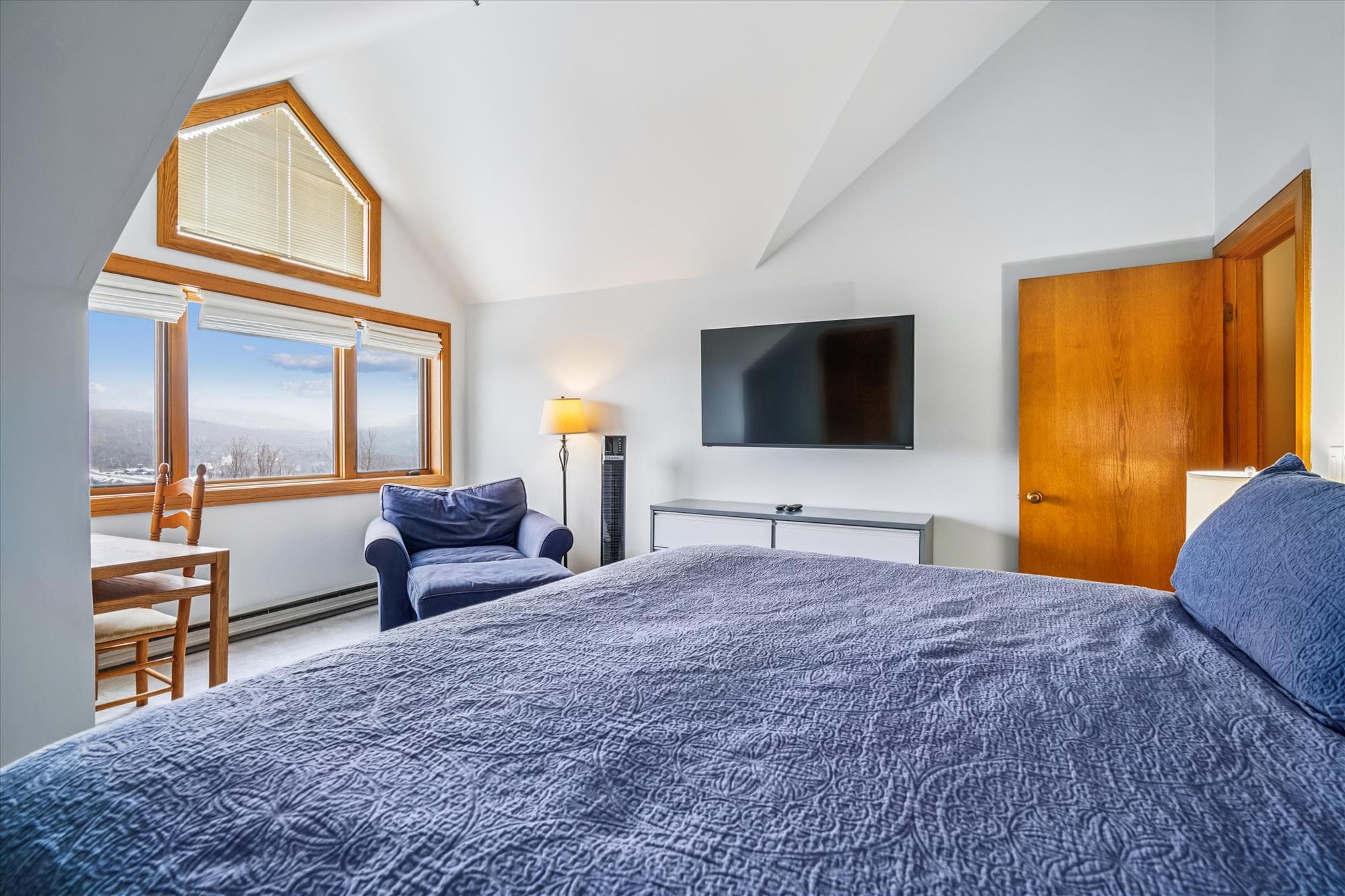 Relax in the upstairs king bedroom while enjoying scenic views through the large windows.