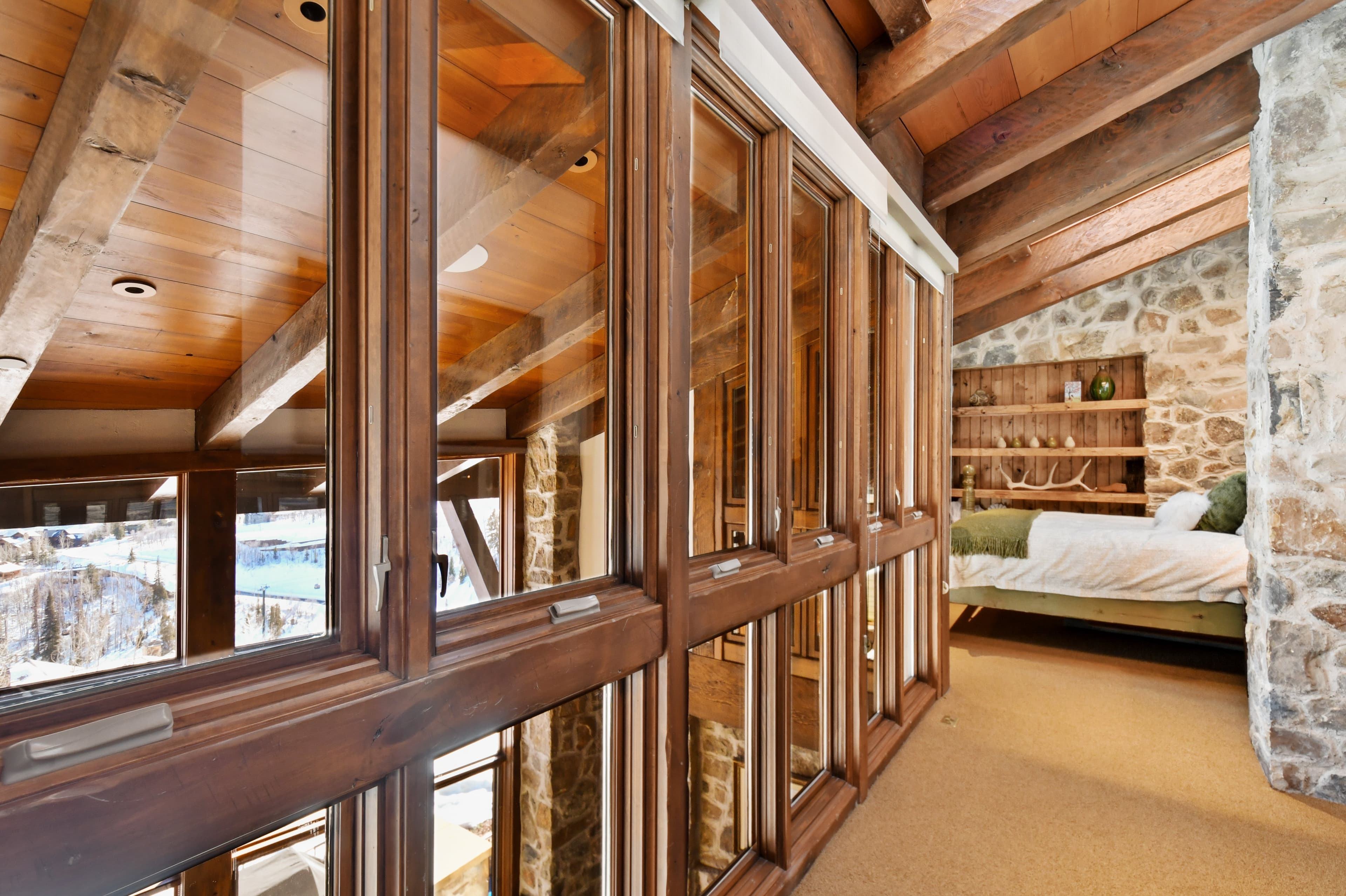 A picture of the windows looking down from the private loft into the main living areas of the home.