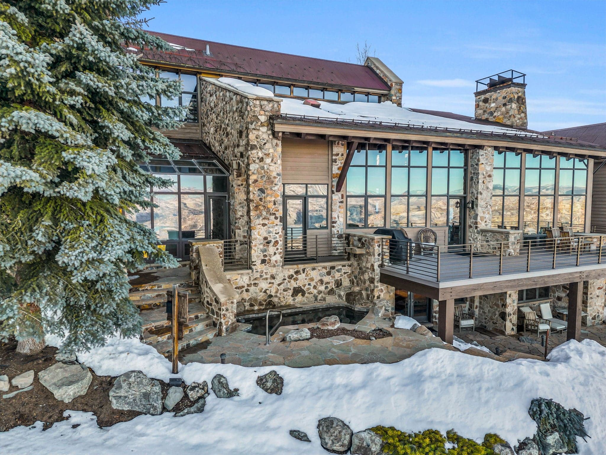 The floor to ceiling windows of this luxury Park City vacation rental reflect the surrounding landscape when viewed outdoors.