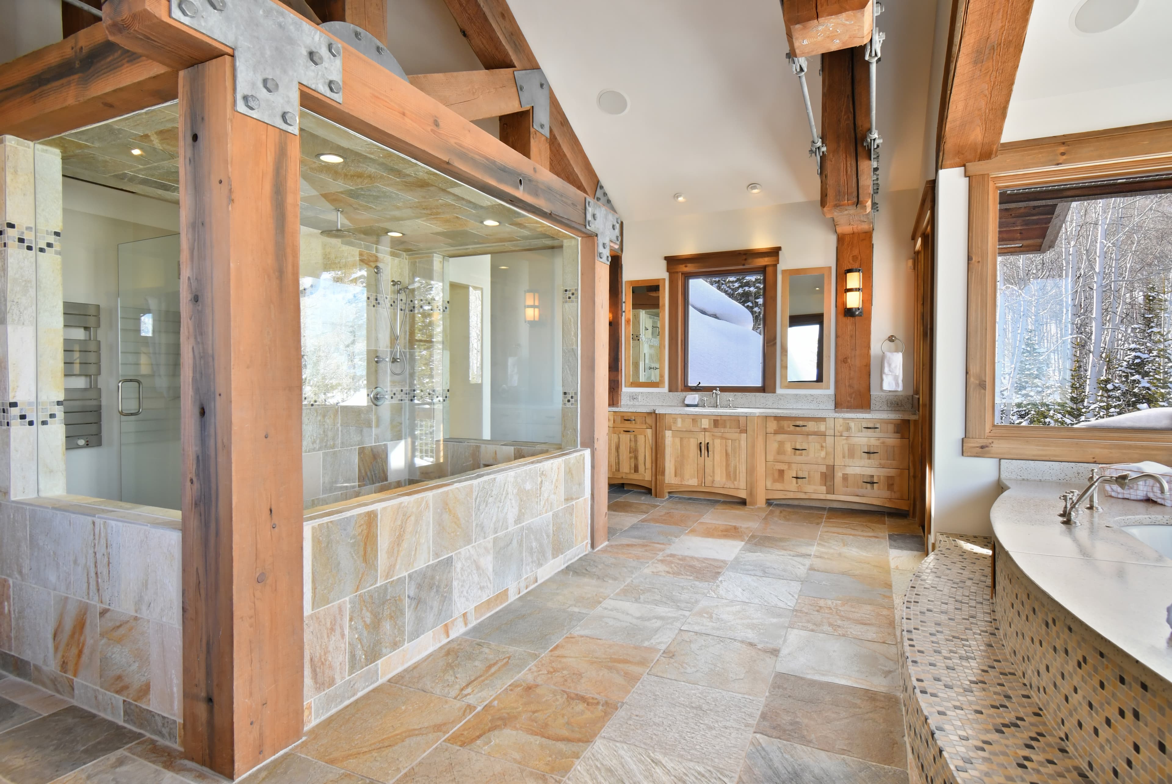 The en-suite bath of the primary bedroom, with a large walk-in shower structure in the middle.