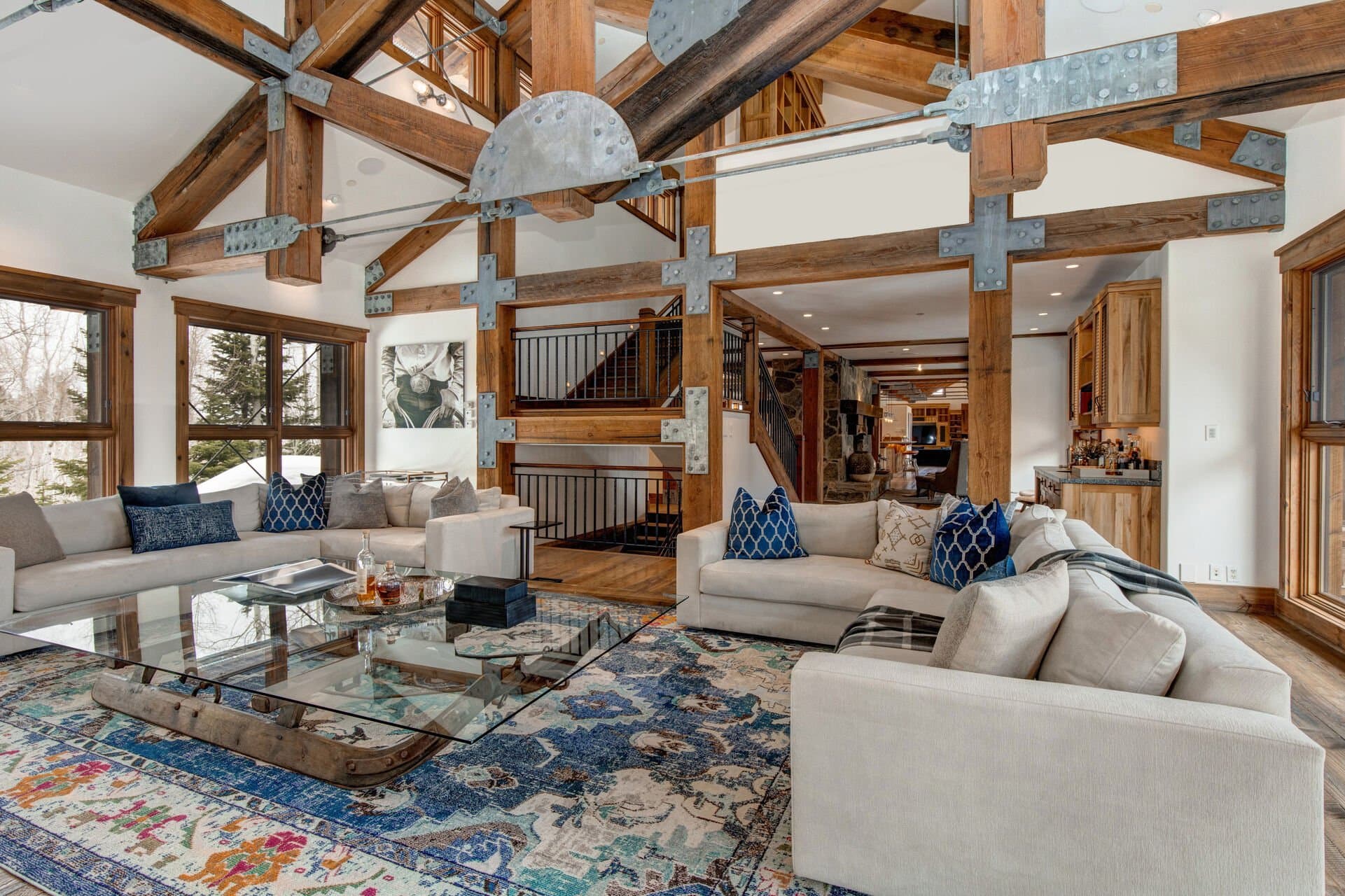 Two sectional couches surround a glass coffee table in the main living space.