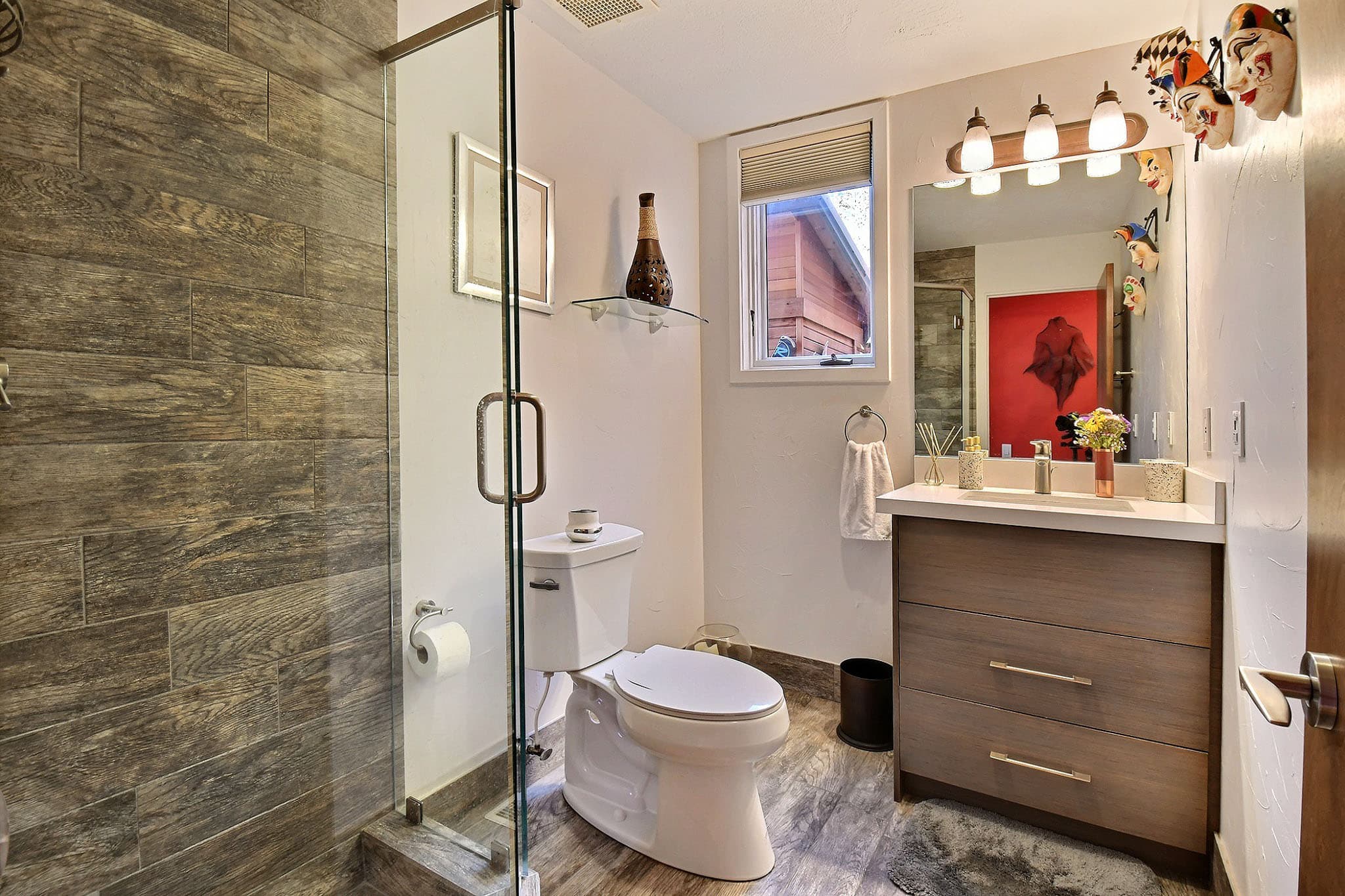 Side View of the Bathroom with a Toilet, Sink, and Walk-In Shower