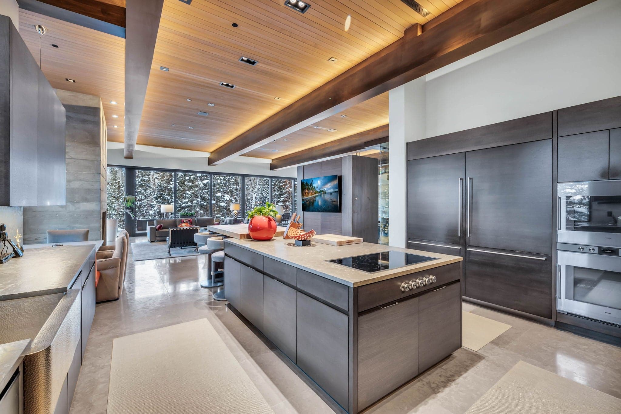A sleek kitchen with high-end finishes and scenic views.
