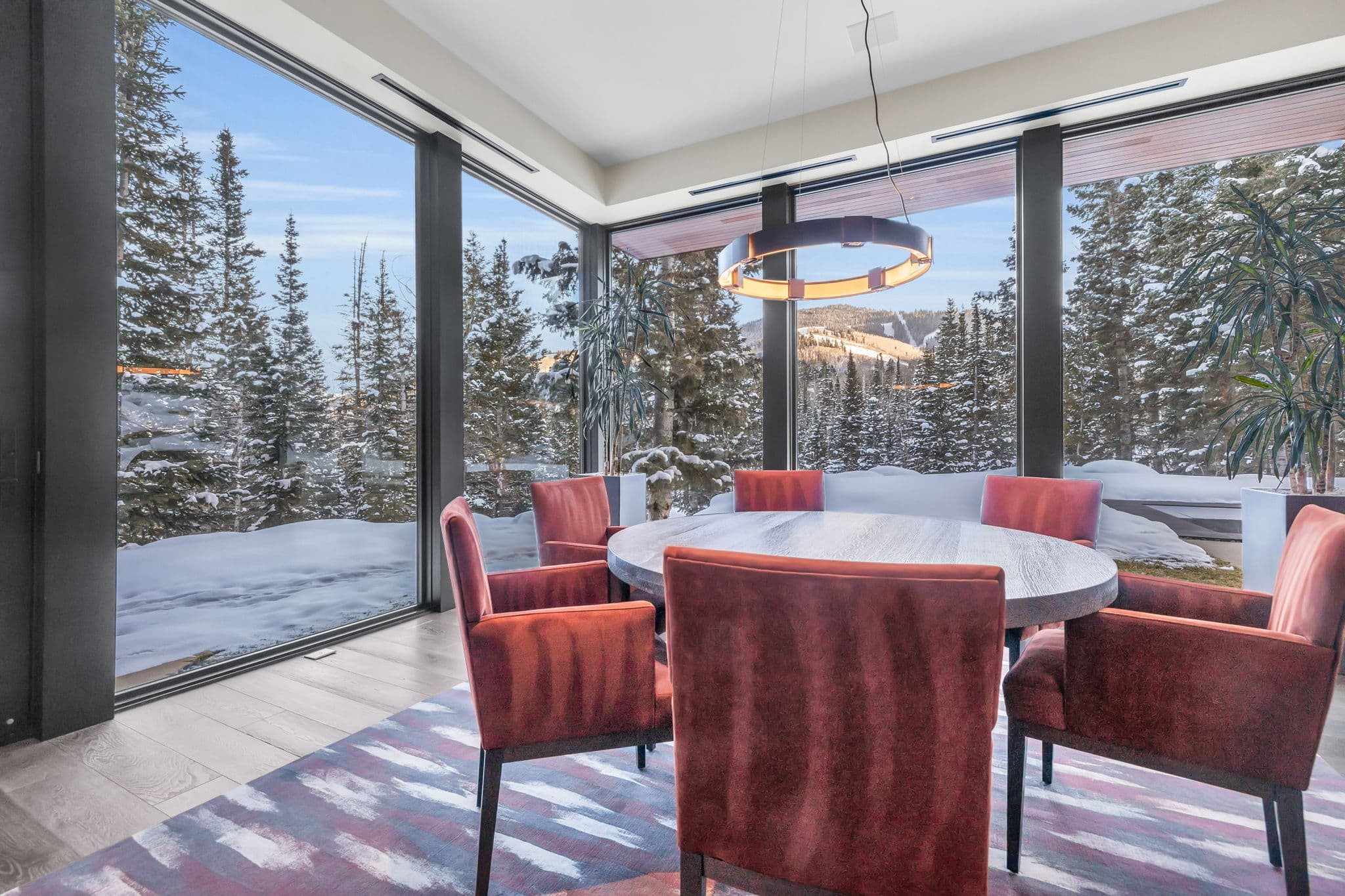 A cozy  dining area with panoramic snowy views.