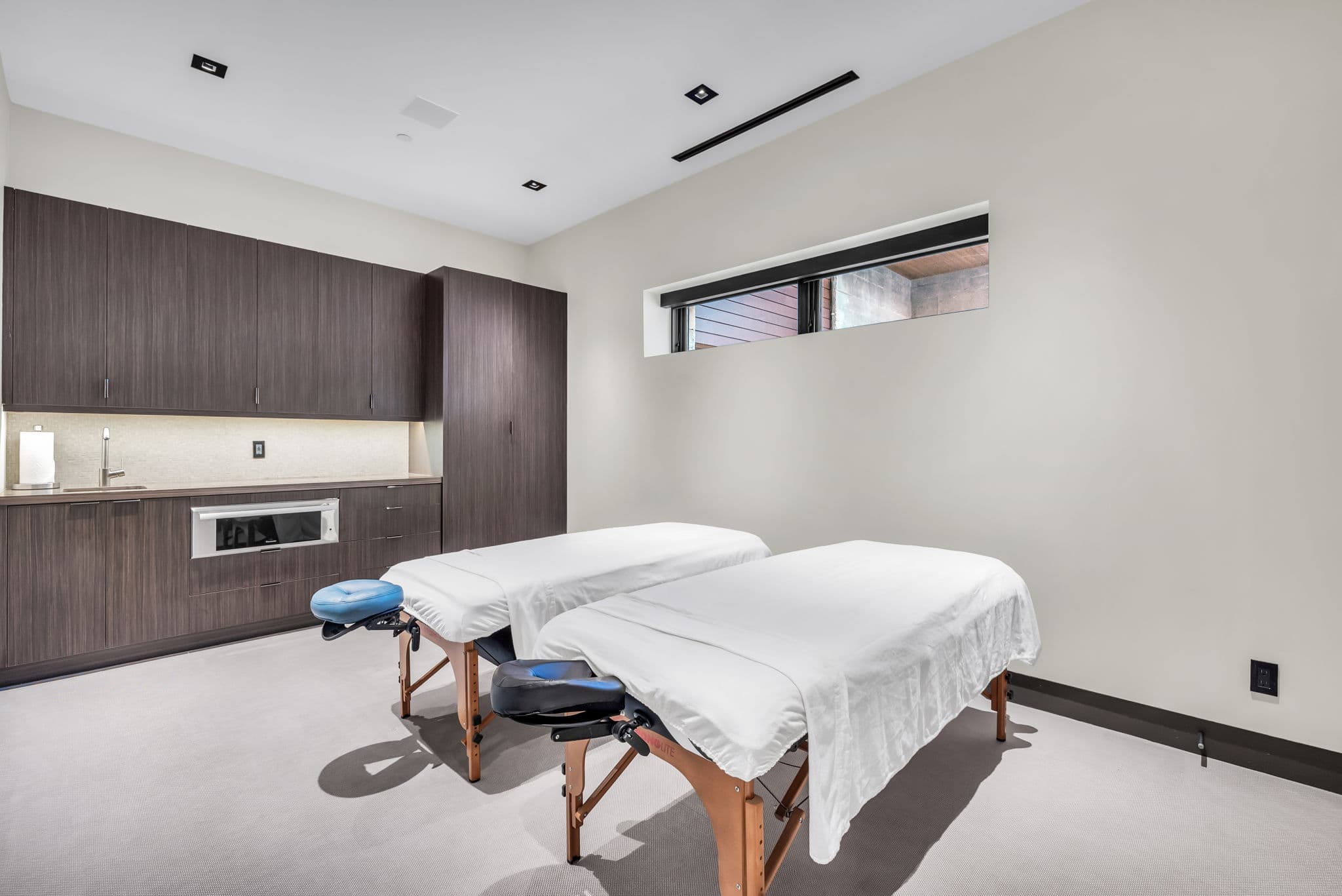 A relaxing  spa room with dual massage tables.