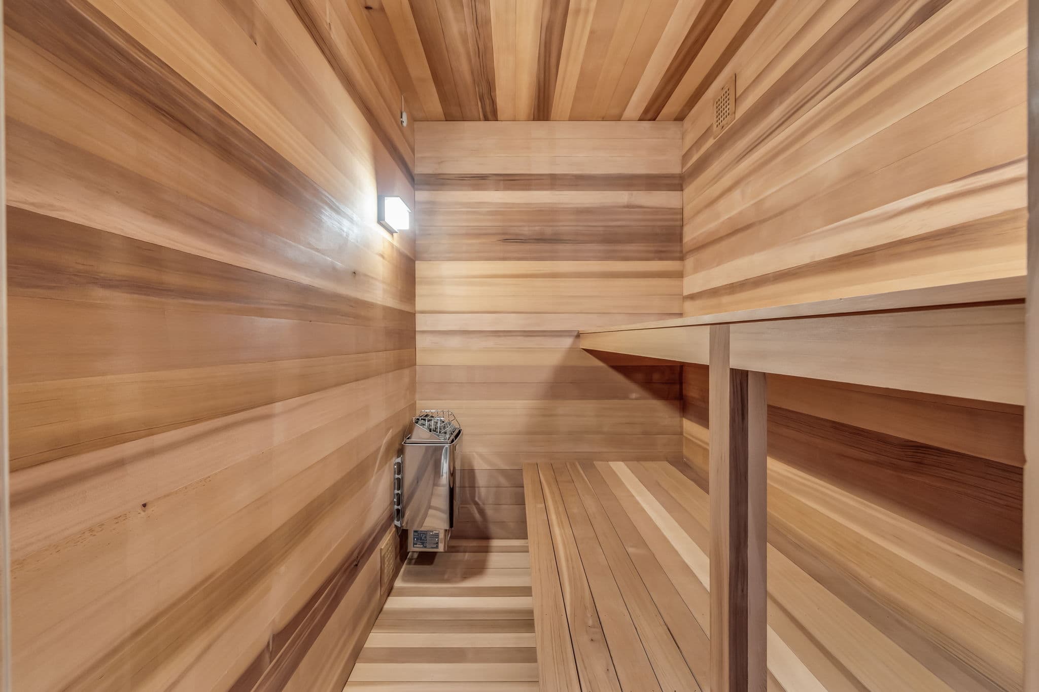 A cozy  sauna with rich wood paneling.