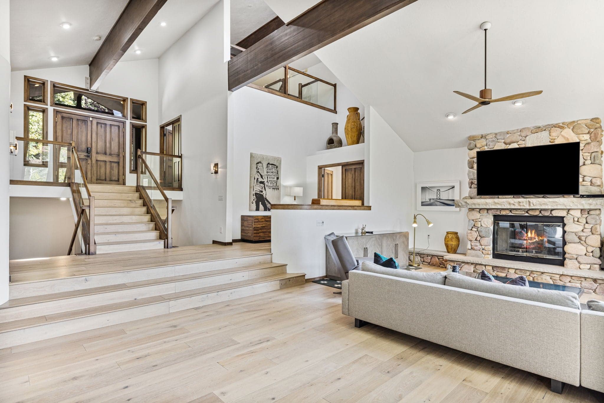 Spacious Living Area With Staircase and Loft.