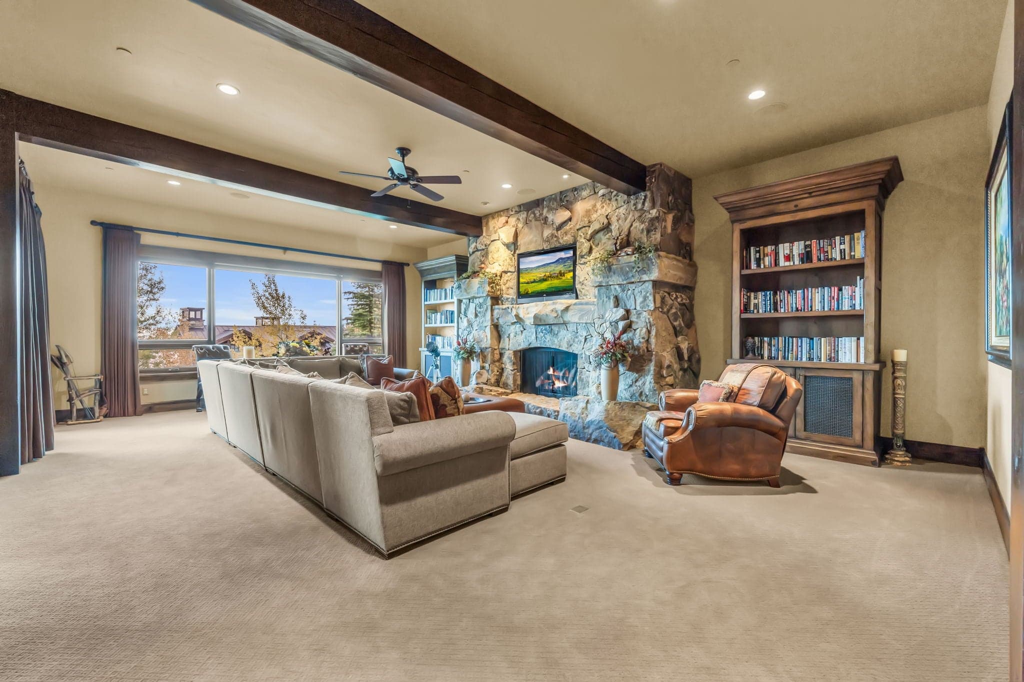 Morning Star upstairs loft with couches, bookshelves, fireplace, and TV.