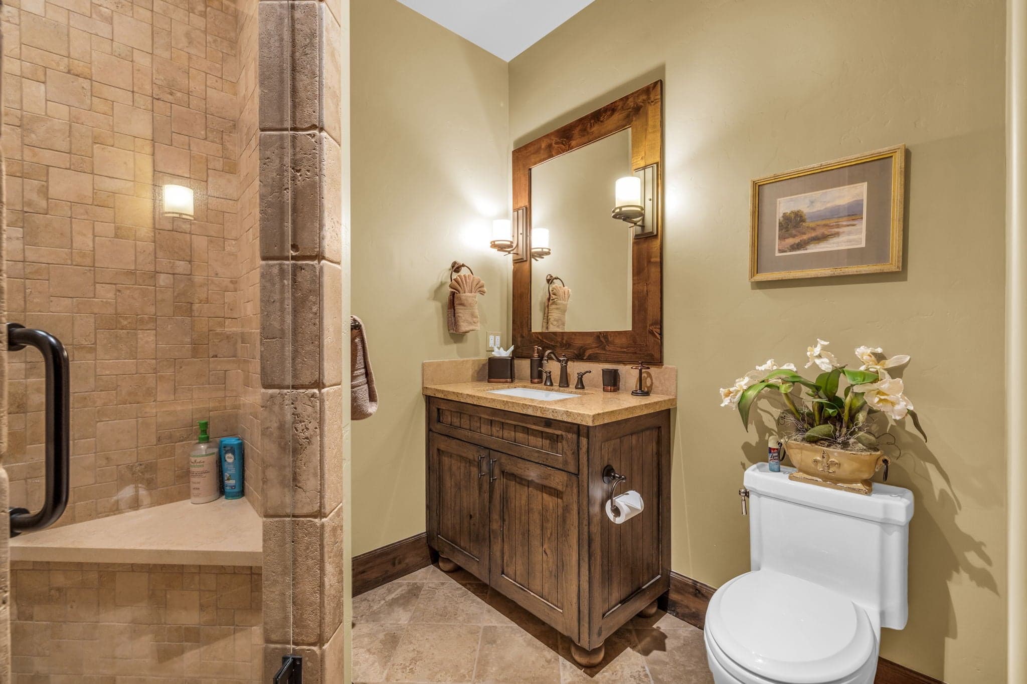 Bathroom in Morning Star at Deer Valley with toilet, sink, mirror and shower.