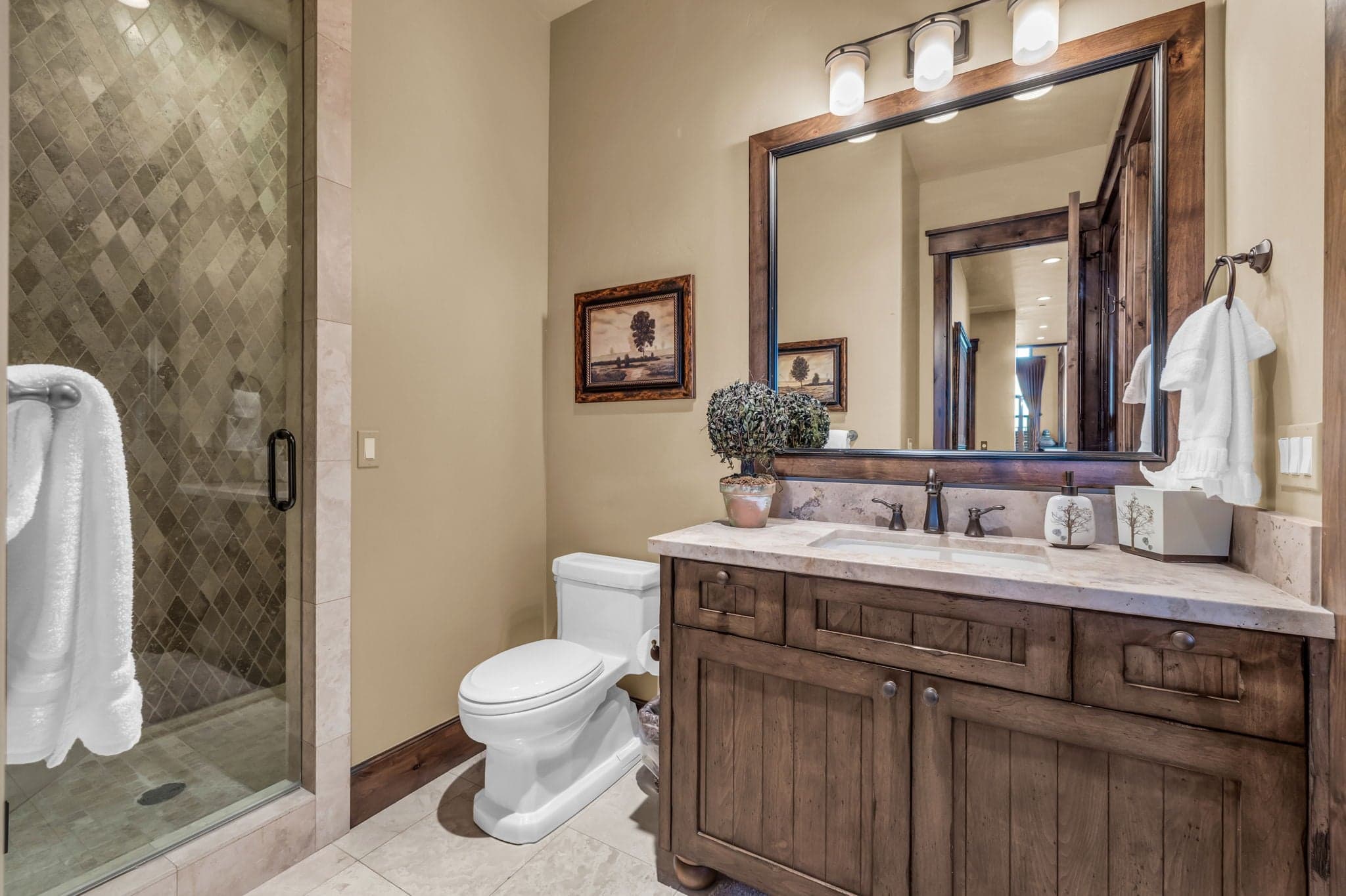 Bathroom in Morning Star at Deer Valley with toilet, sink, mirror and shower.