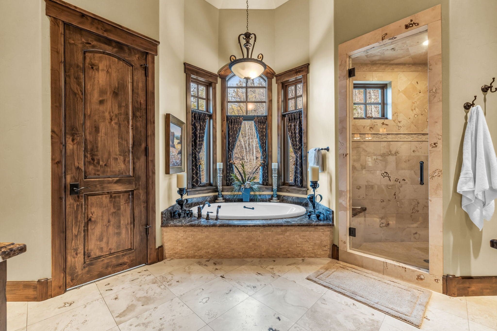 Bathroom in Luxury Park City vacation rentals with marble tub and glass shower.