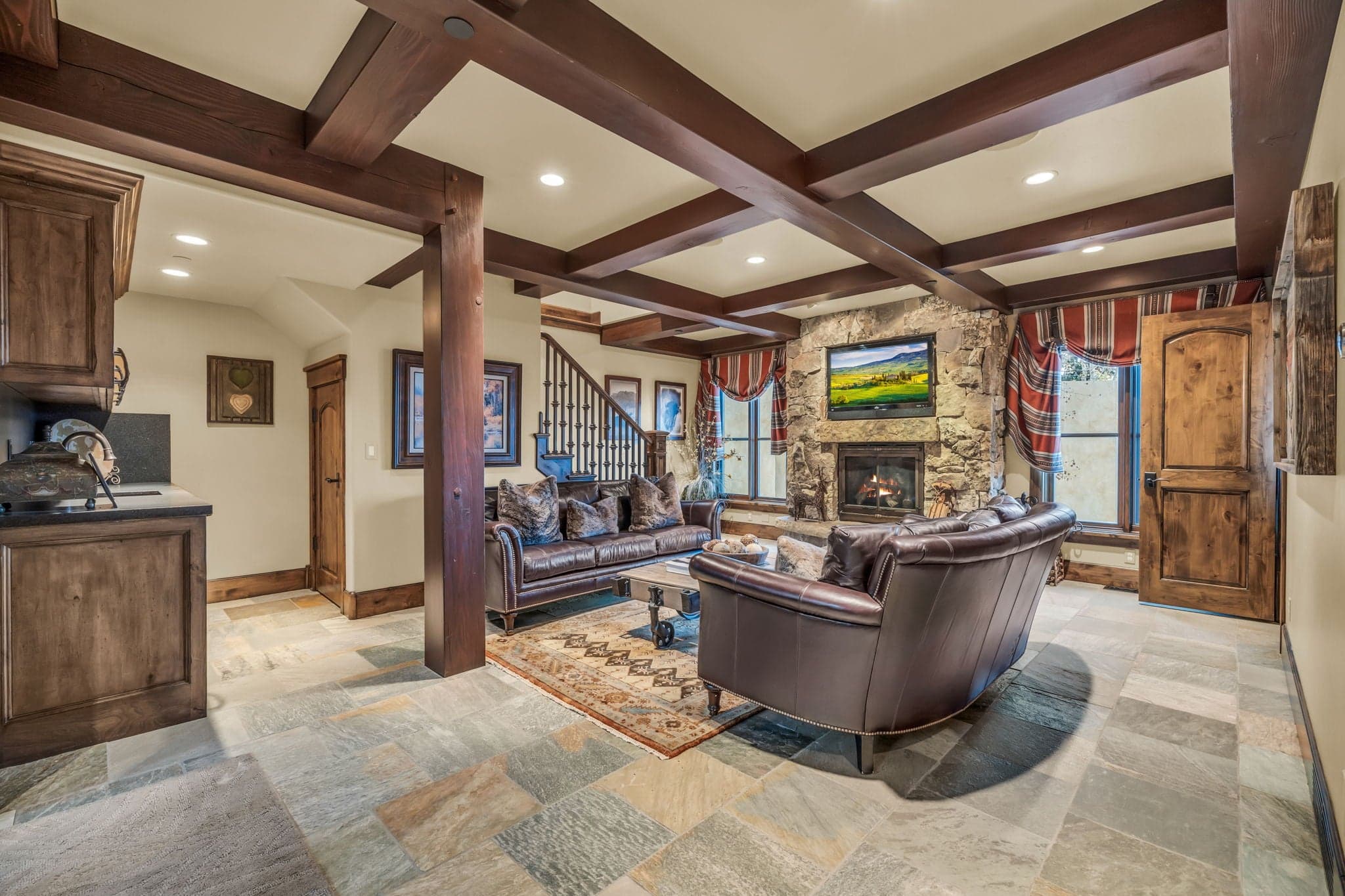 Living room with two couches, a fireplace, and a mounted TV.