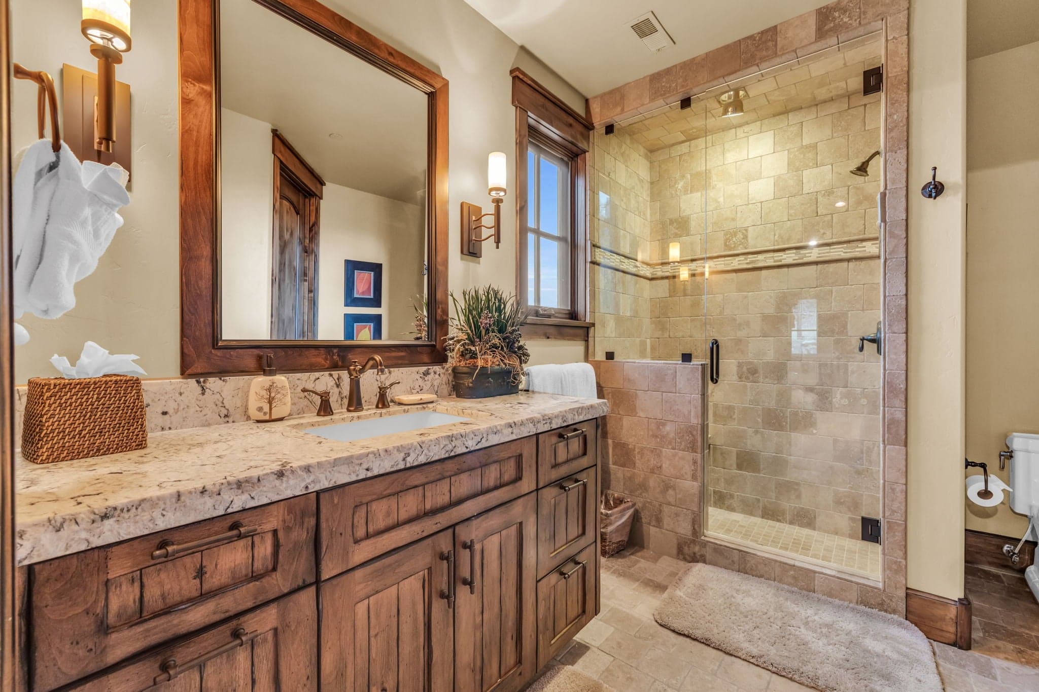 Bathroom in Morning Star at Deer Valley with toilet, sink, mirror and shower.