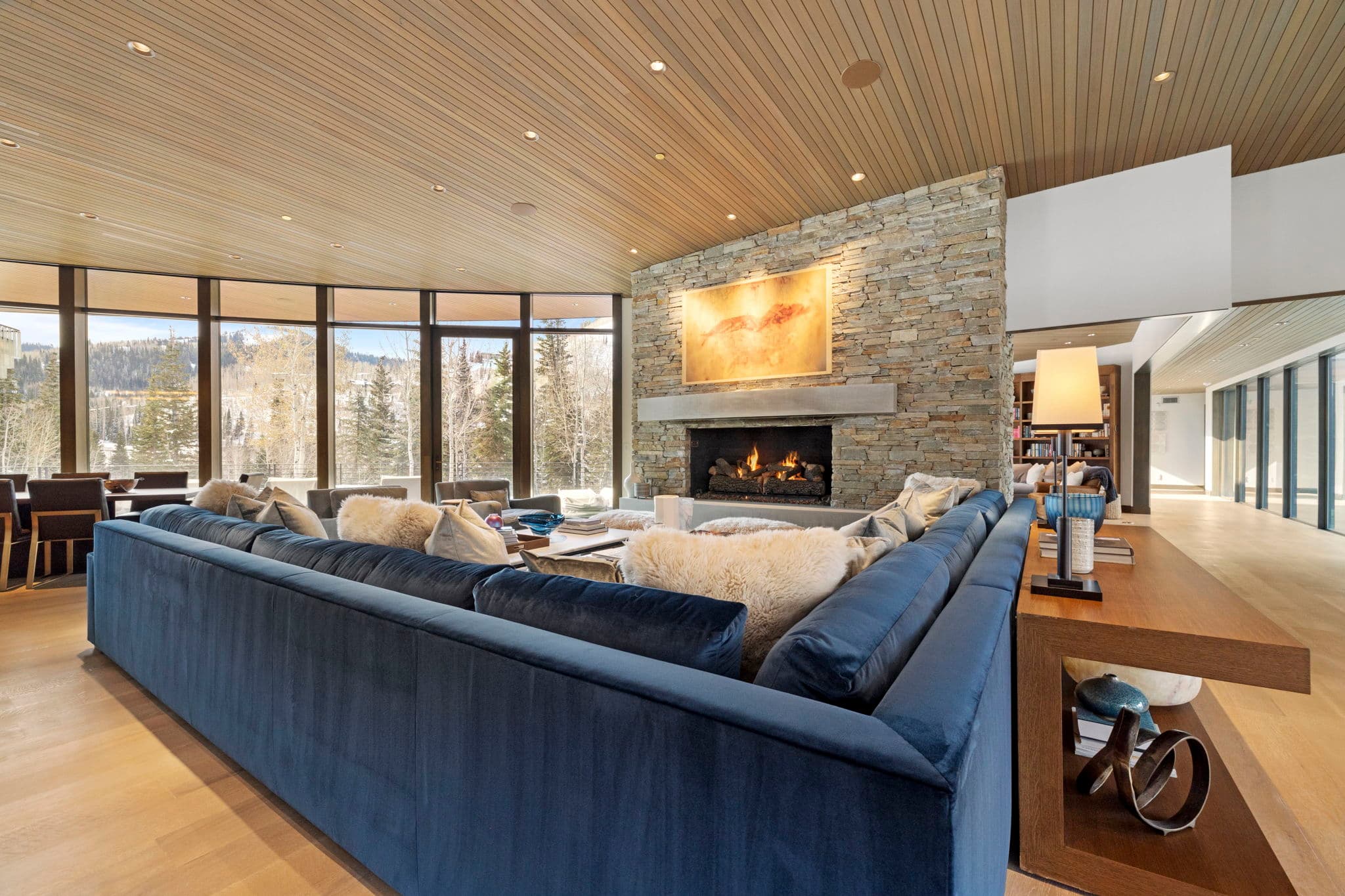 A view of the living area with a large sofa and a fireplace.
