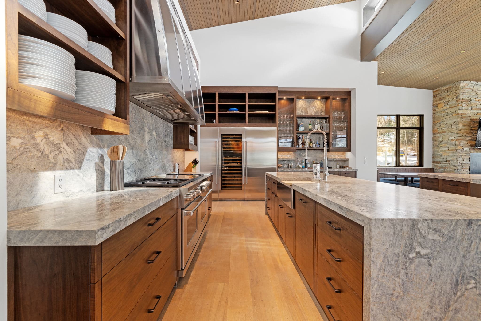 A view of the kitchen with a stove, cabinets, and kitchenware.