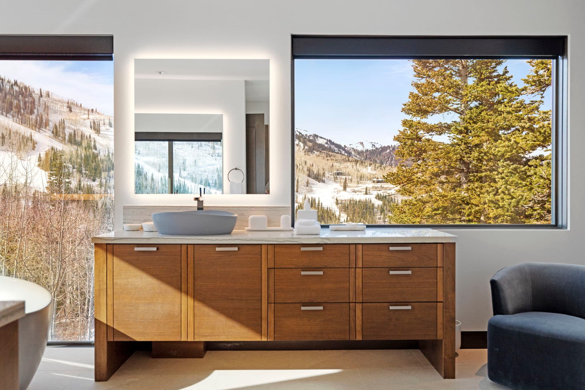A bathroom sink with a mirror and   storage space.
