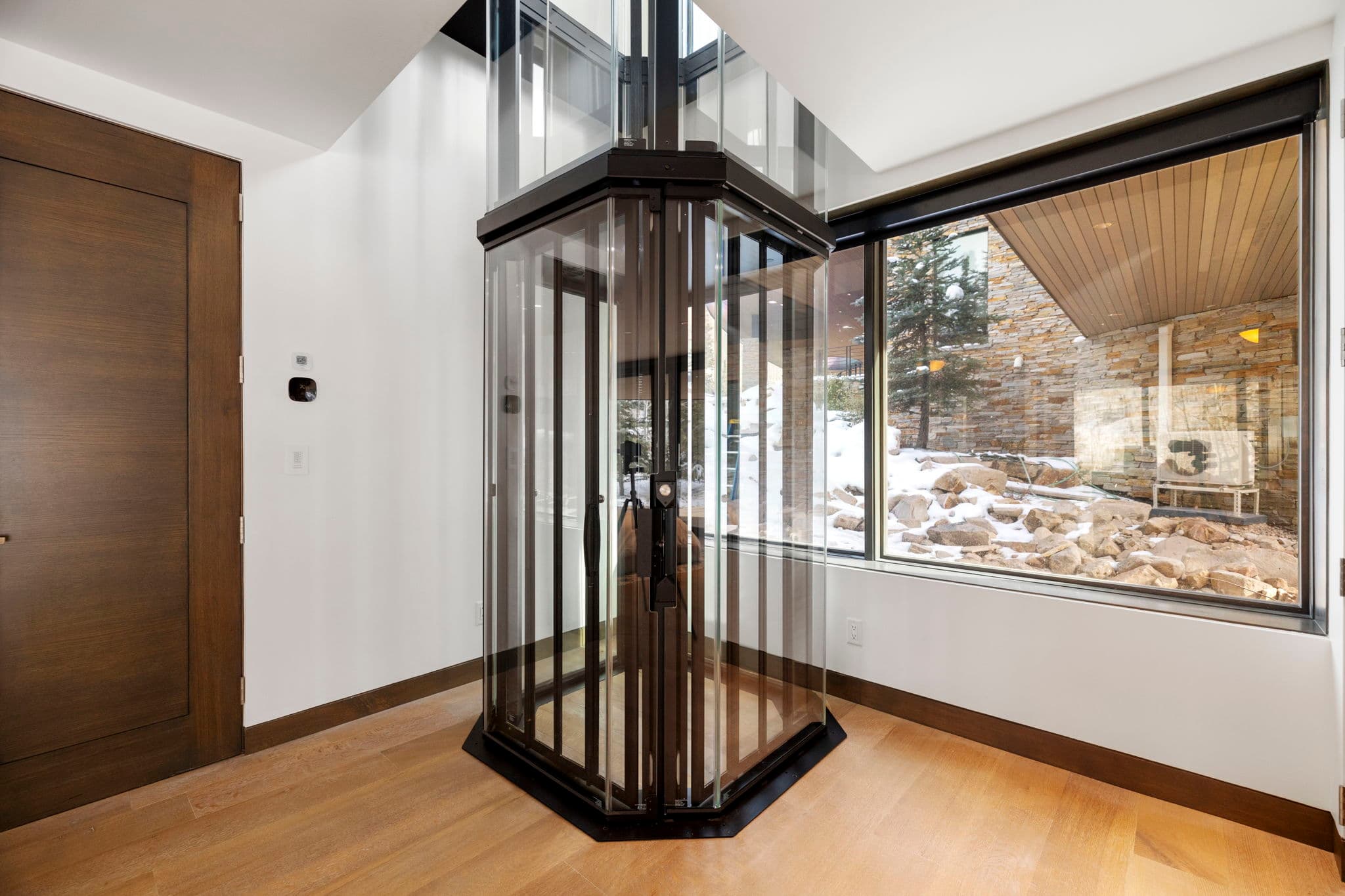 An elevator with glass doors.
