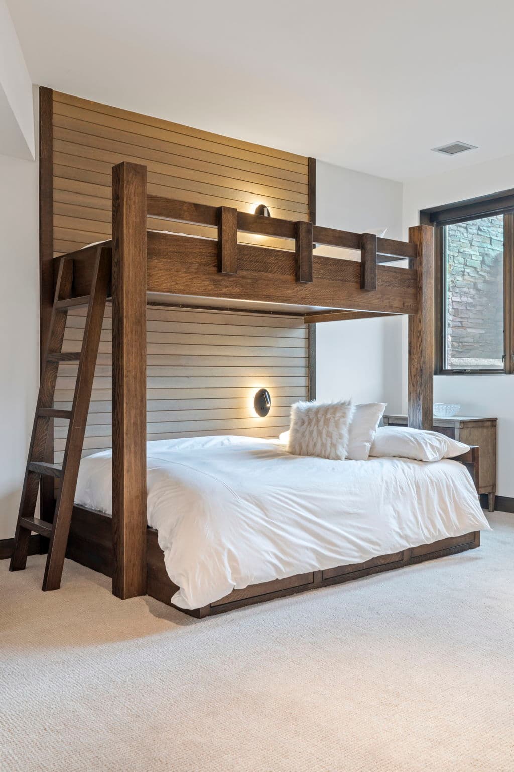 A close-up view of a bunk bed with a ladder.
