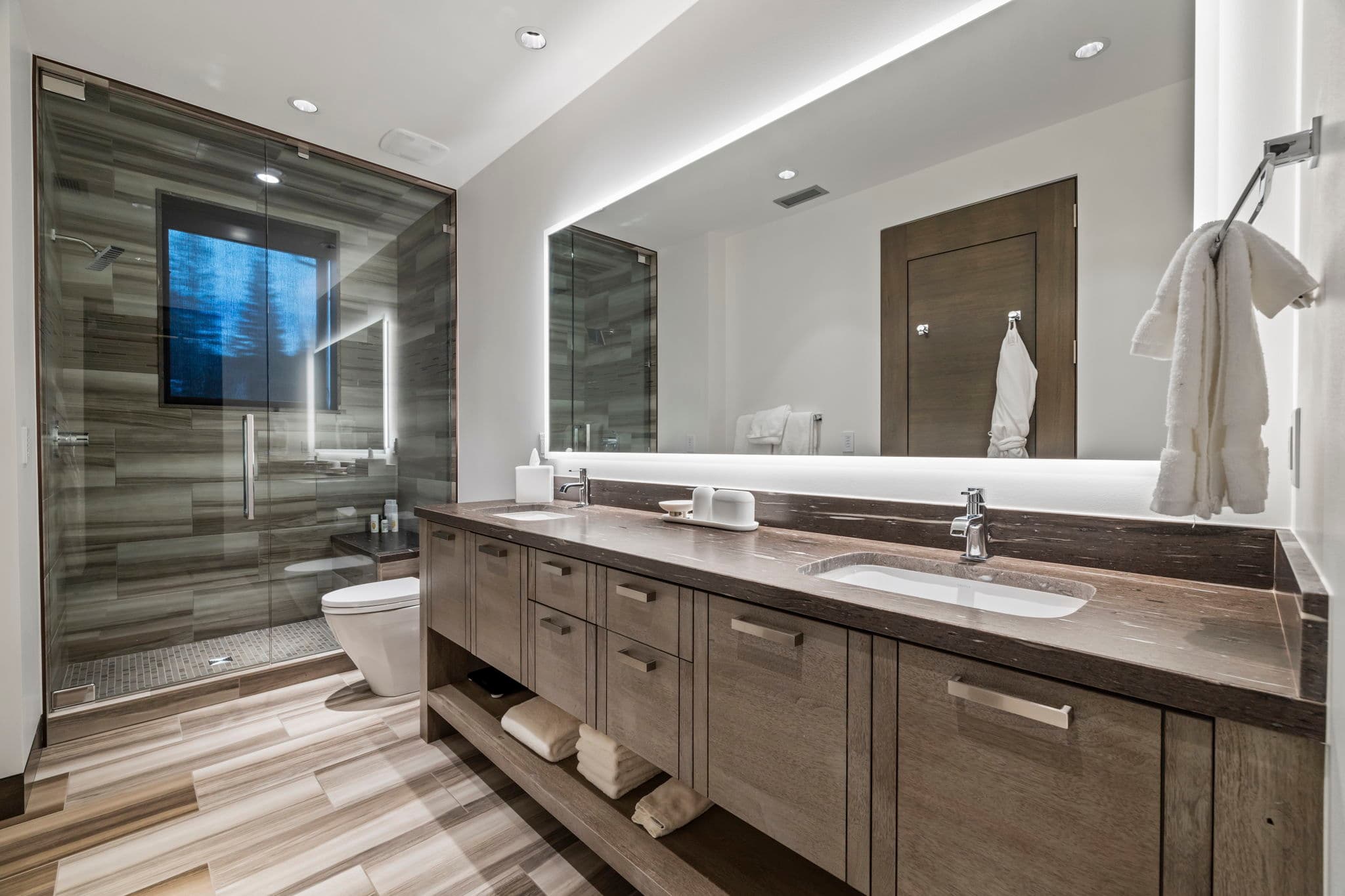 A large modern bathroom with two sinks and a shower.