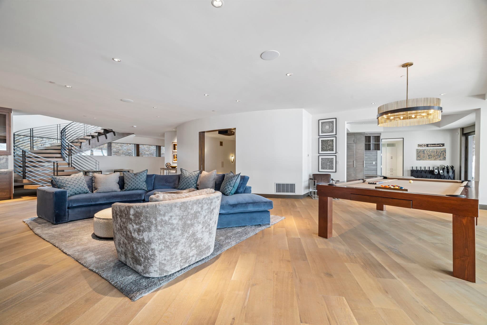 A seating area next to a wood pool table.
