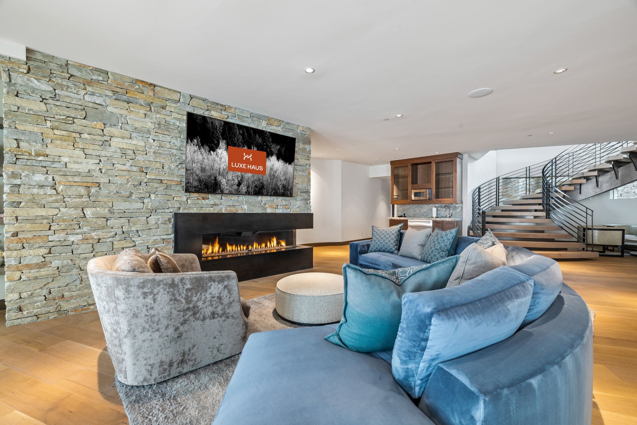 A cozy seating area with a fireplace and a flatscreen tv.