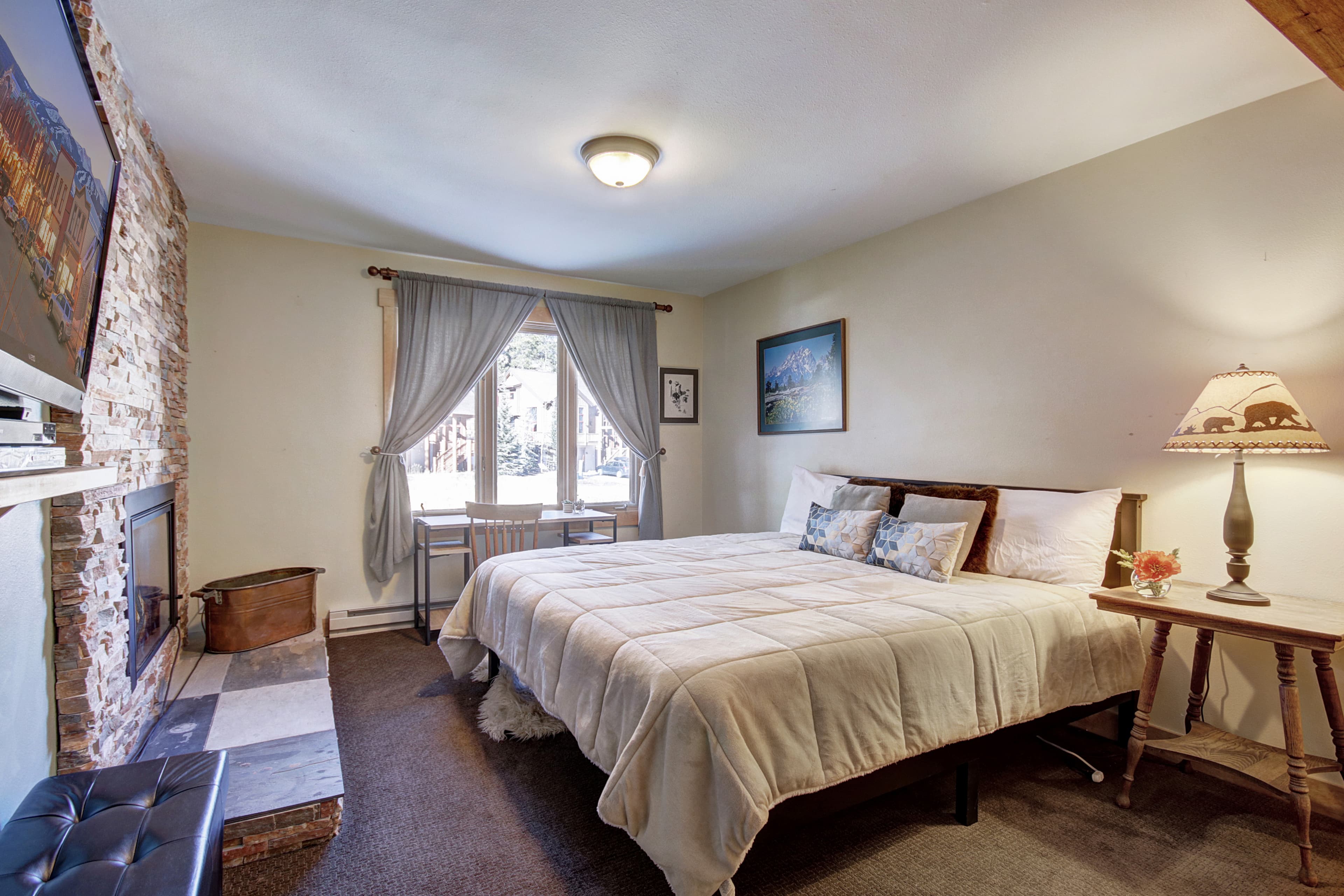 King-size bed located in the lower level bedroom - 4 O'Clock Lodge D26 Breckenridge Vacation Rental