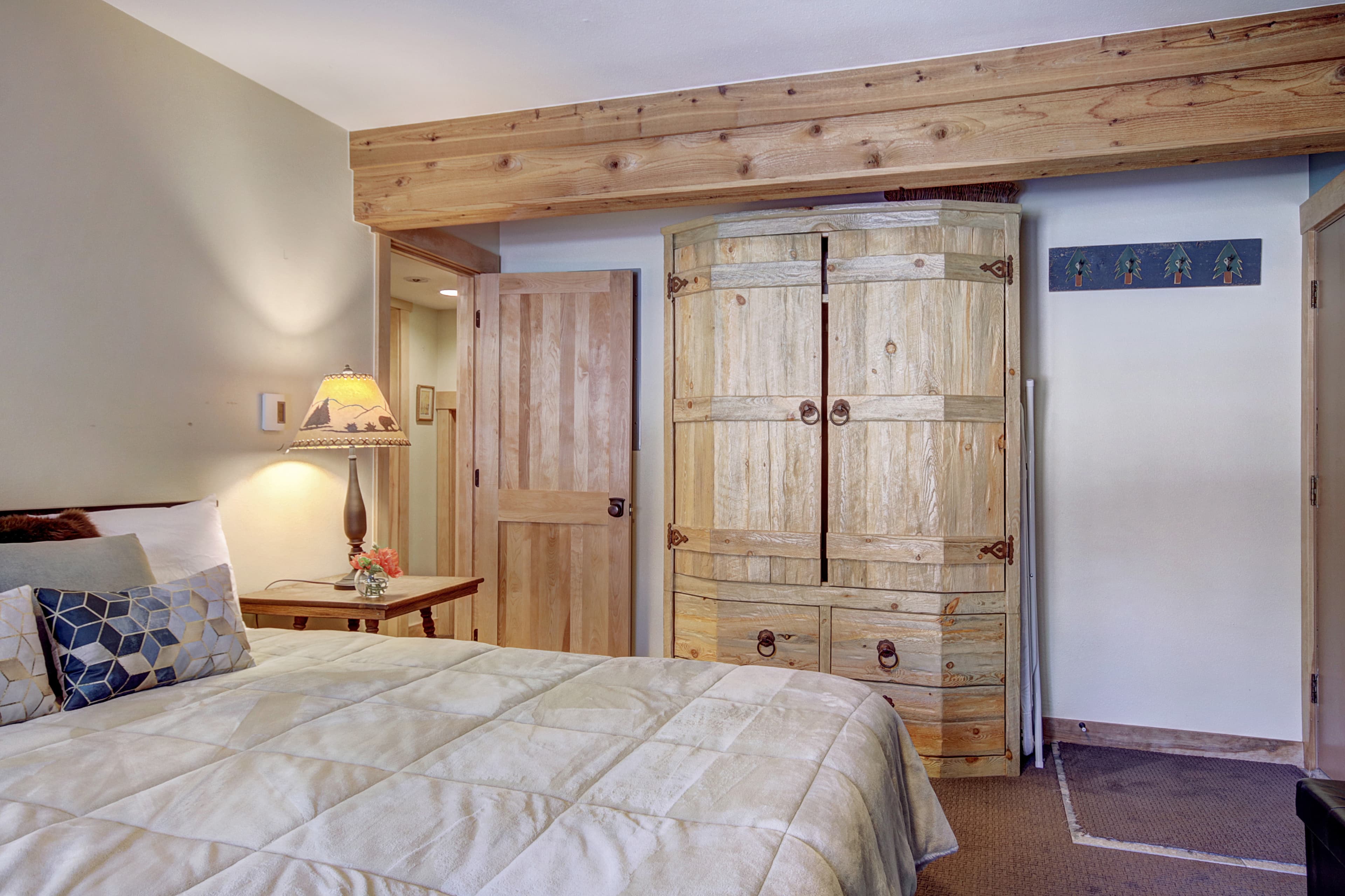 King-size bed located in the lower level bedroom - 4 O'Clock Lodge D26 Breckenridge Vacation Rental