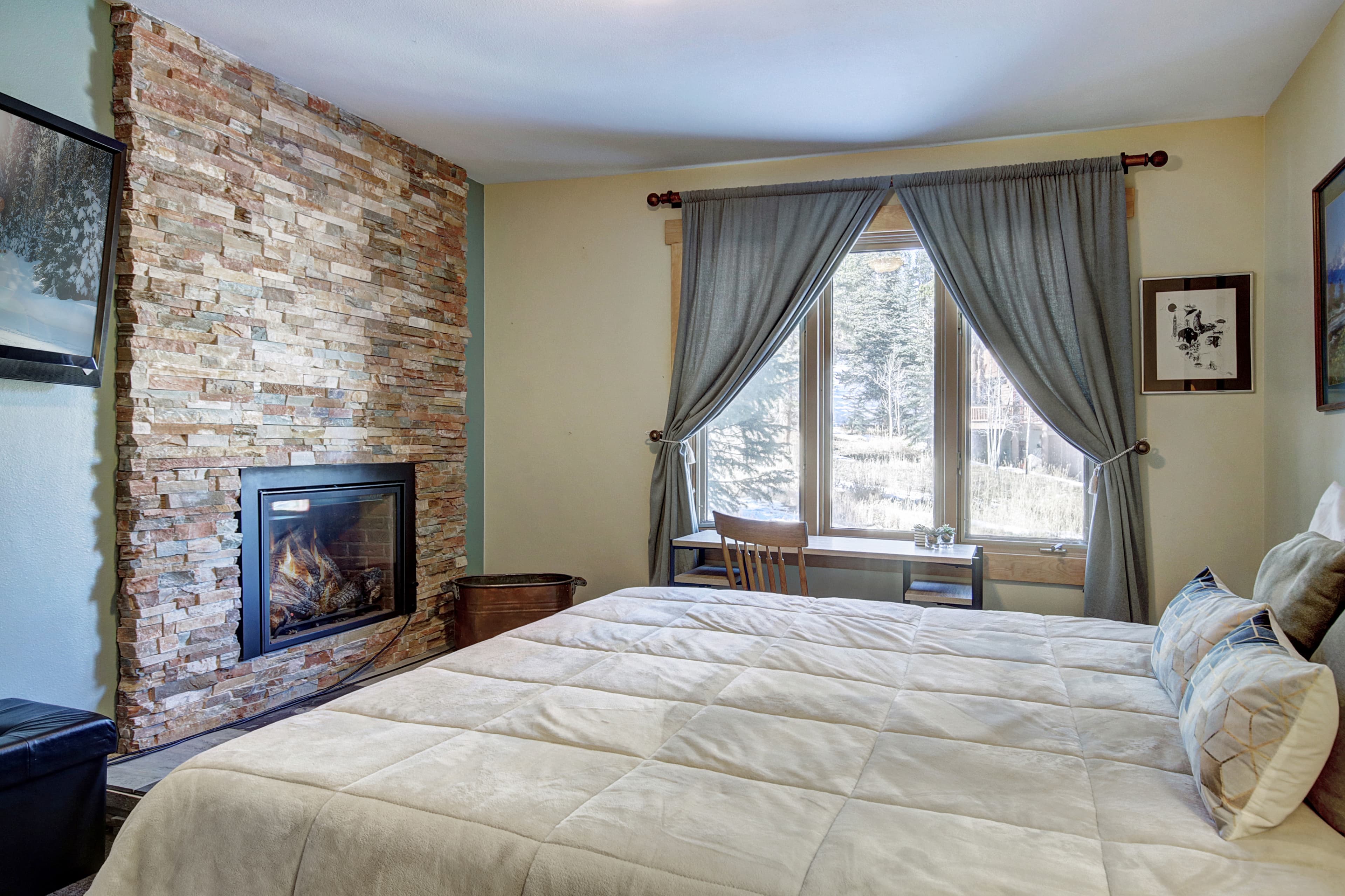 King-size bed located in the lower level bedroom - 4 O'Clock Lodge D26 Breckenridge Vacation Rental