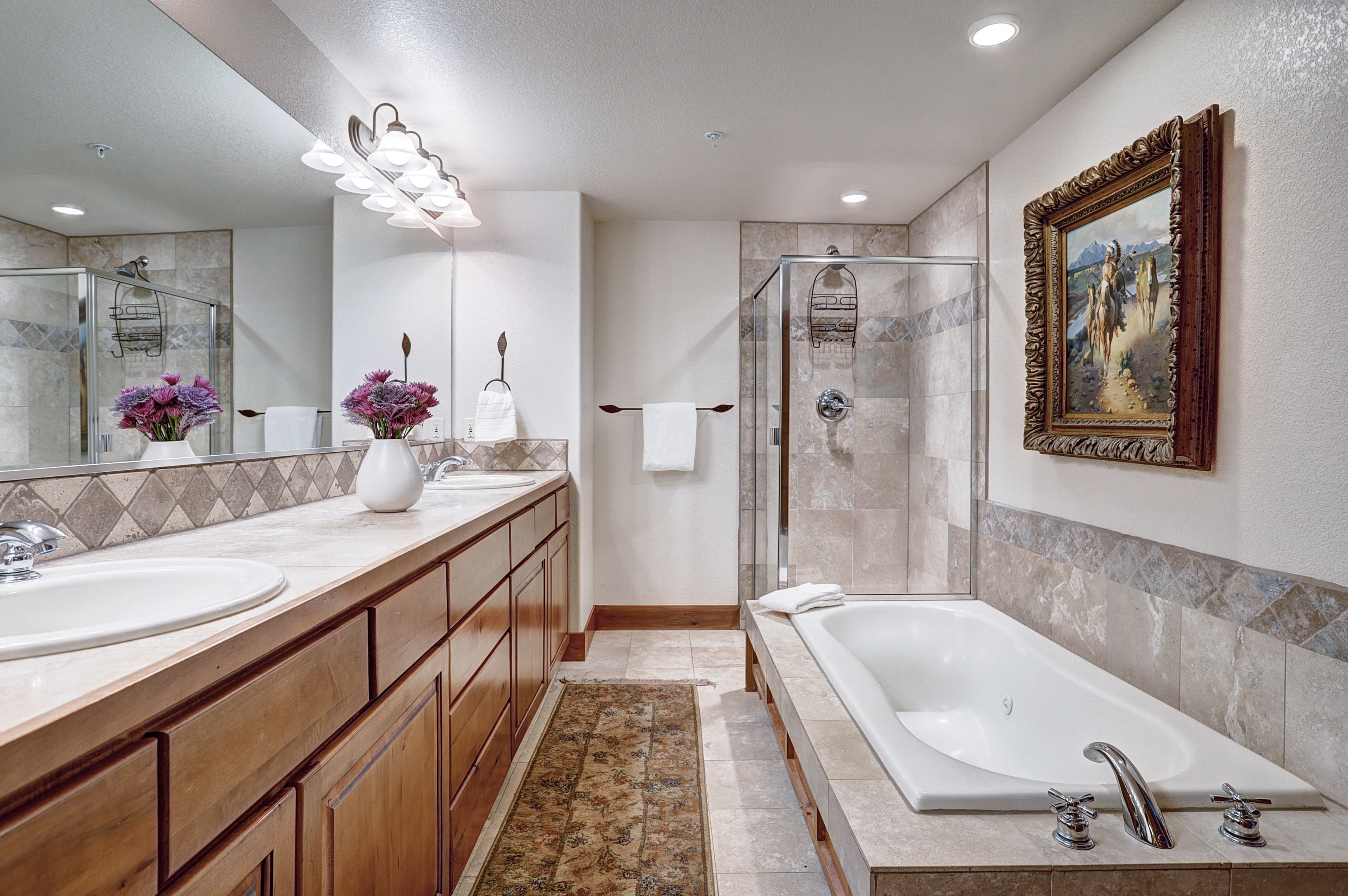 Relax in a bubble bath in this large primary bathroom - Amber Sky Breckenridge Vacation Rental