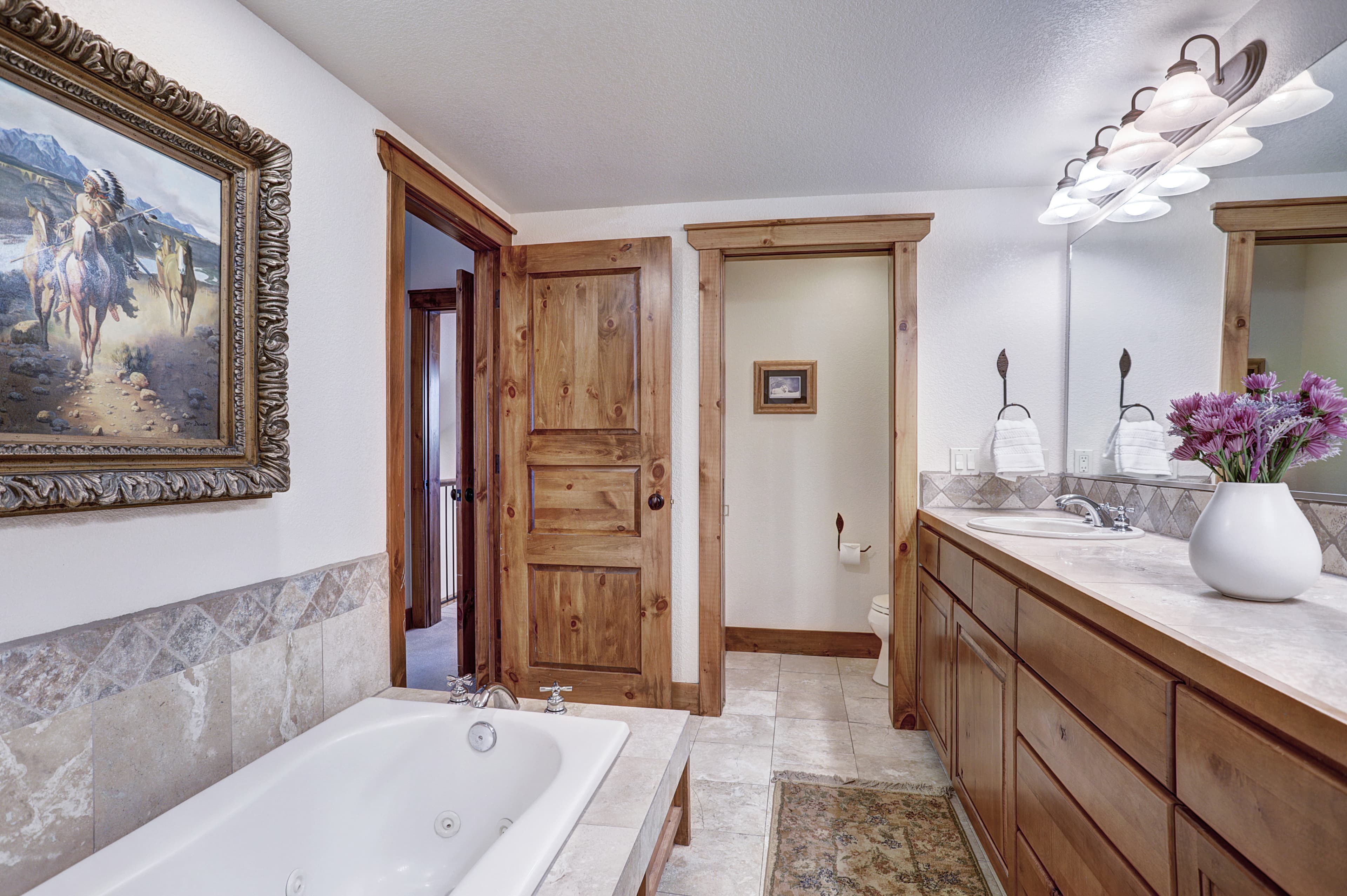 The primary bathroom offers a large bathtub, walk in shower and double vanity sinks - Amber Sky Breckenridge Vacation Rental