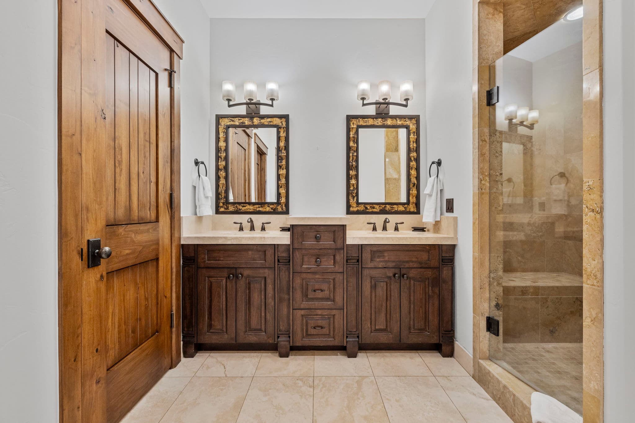 guest bathroom with dual vanities and luxurious cabinetry