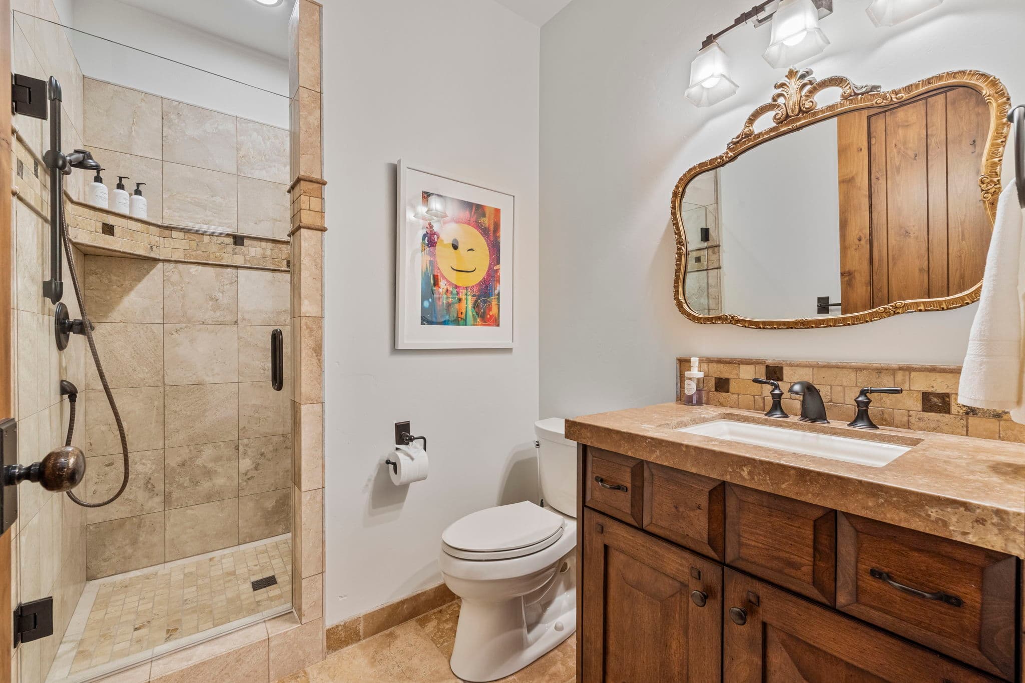 bathroom for game room with shower, vanity and toilet