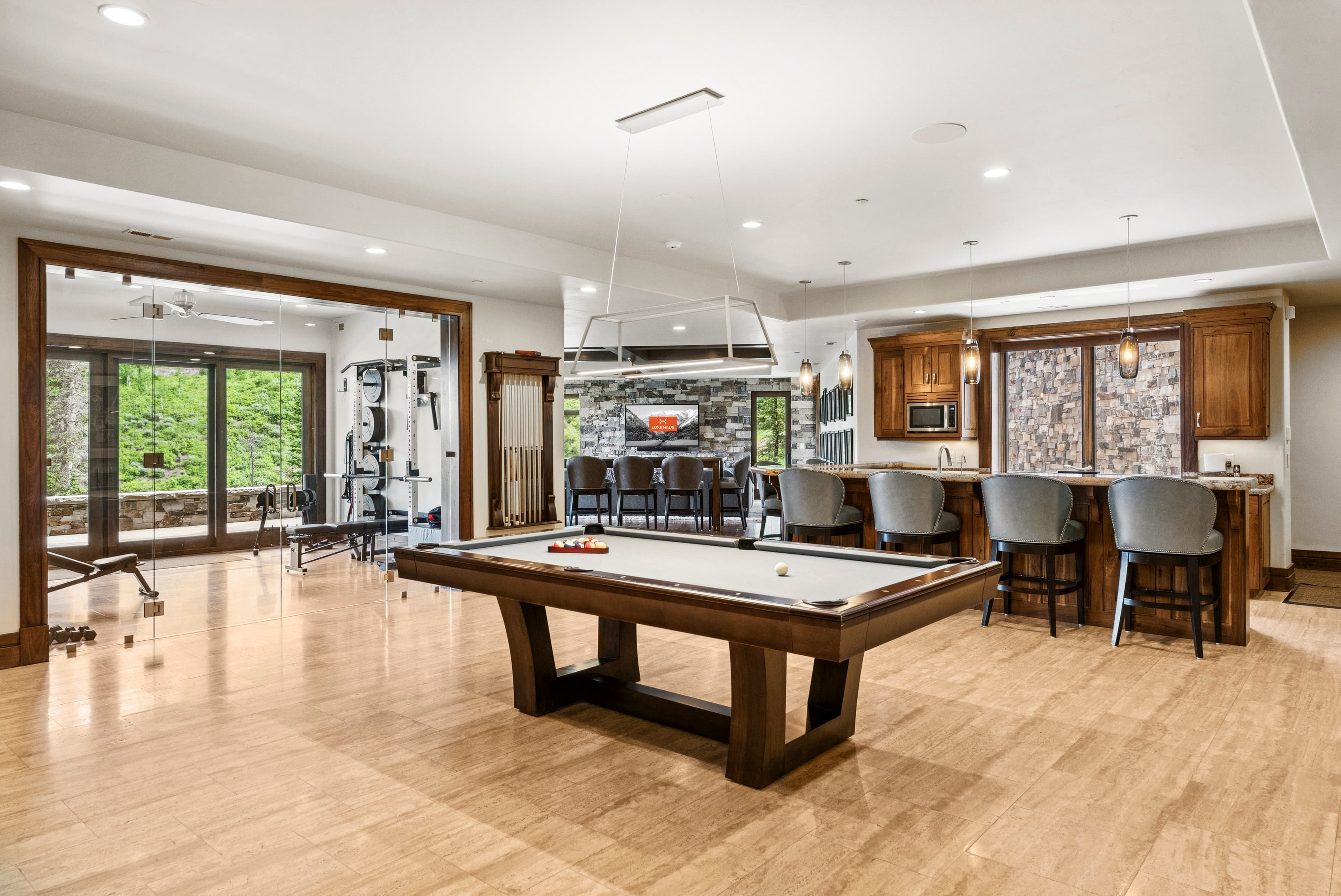 pool table with wet bar and large flat screen tv