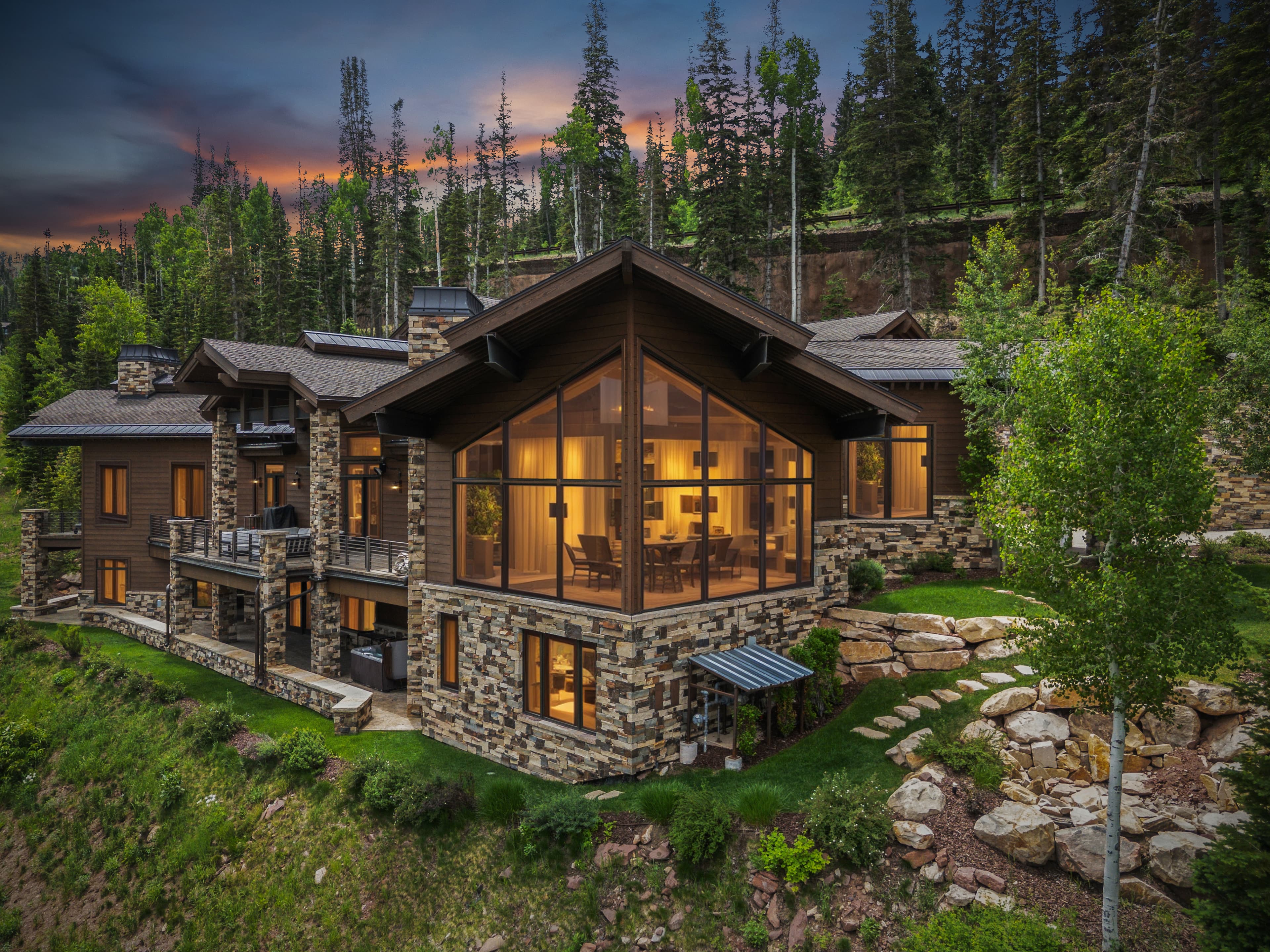a view from the outside of a-frame shaped windows in the gran room of grandview