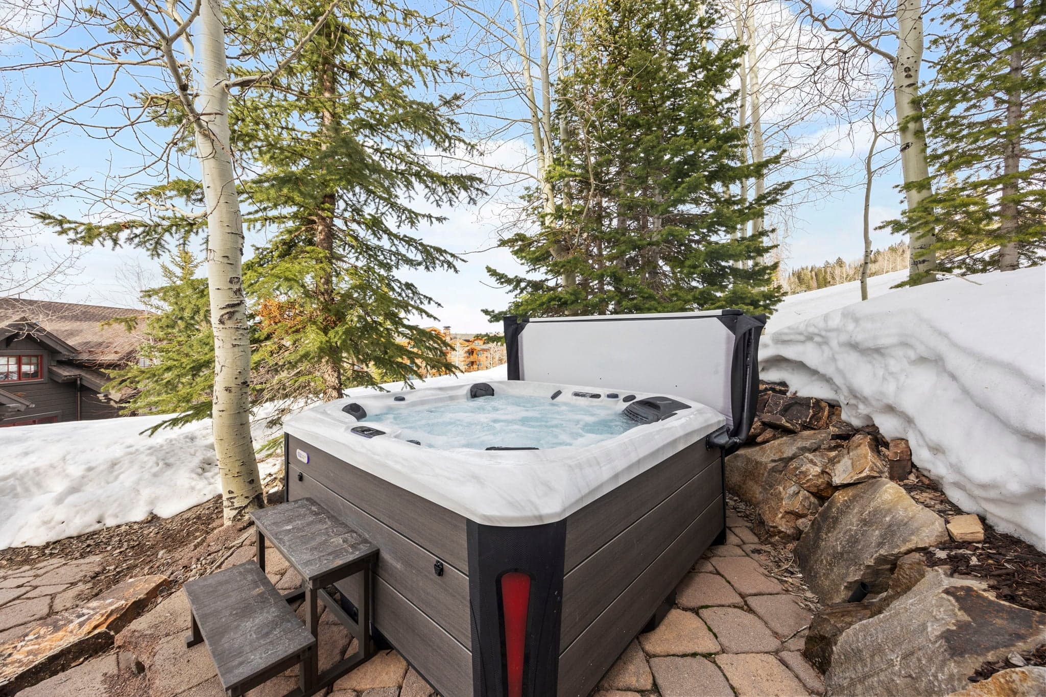 A view of the hot tub with ski slopes in the distance