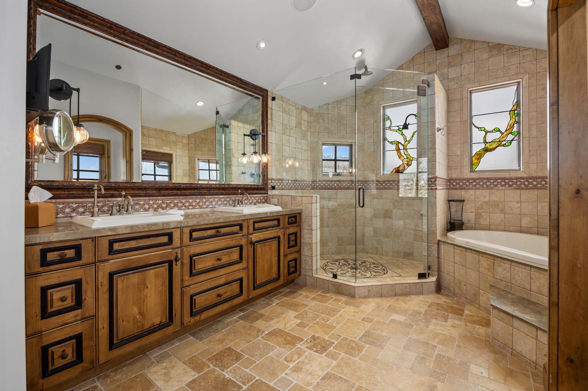 grand primary en suite bath with soaking tub and large glass shower