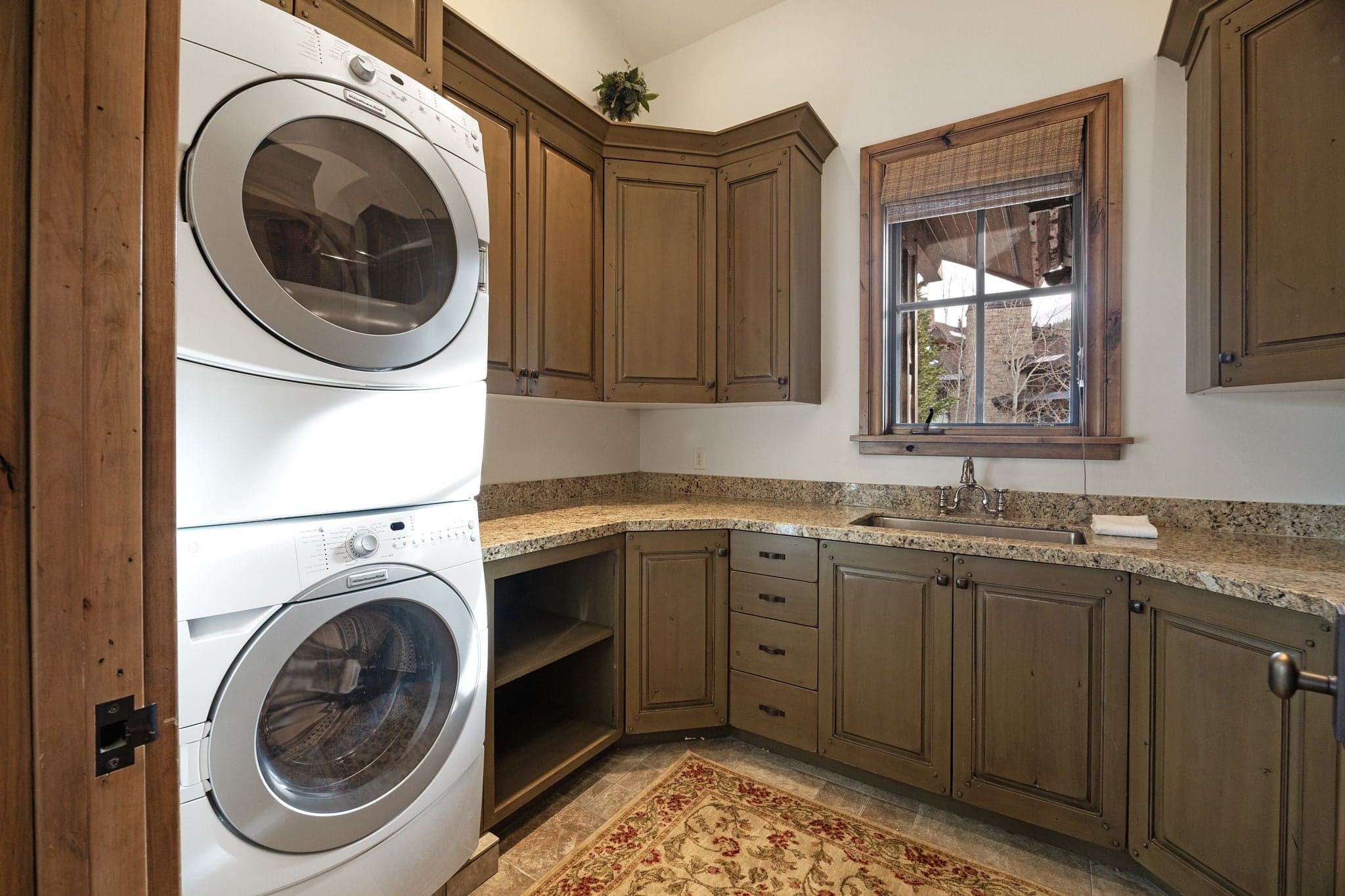 laundry room with stacking washer and dryer