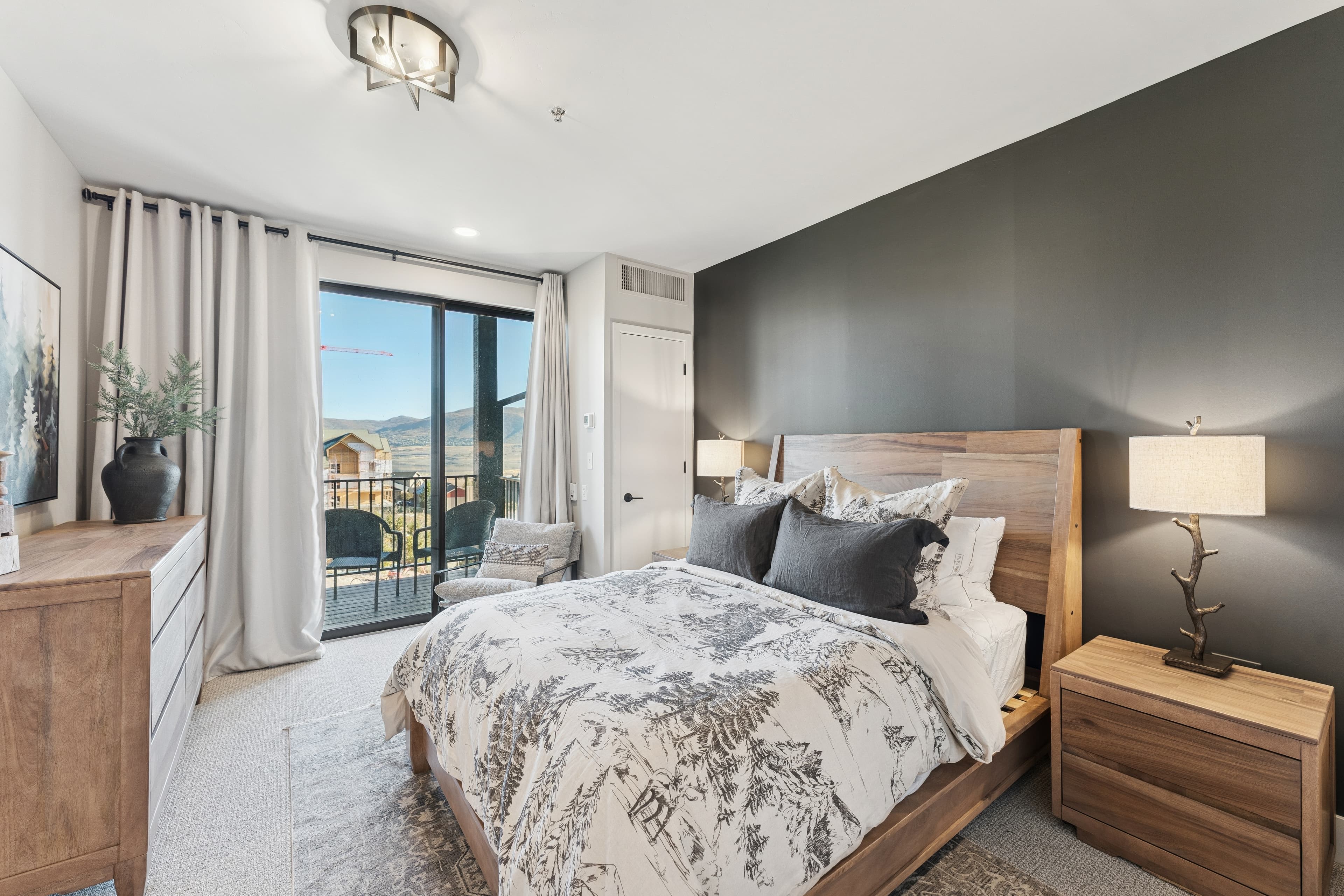 Cozy, modern living room in a Park City condo with a fireplace, mountain views, and rustic-chic décor.